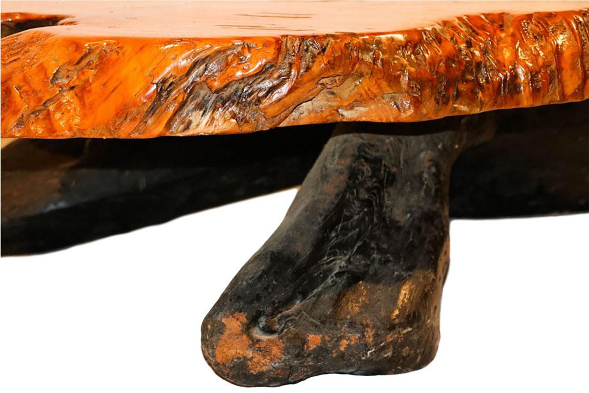 This impressive live edge wood tree slab coffee table features natural stump base hardwood construction with thick tree slab top. An exceptionally artful and large vintage, amorphous live edge table with natural tree trunk stump base. The brown top