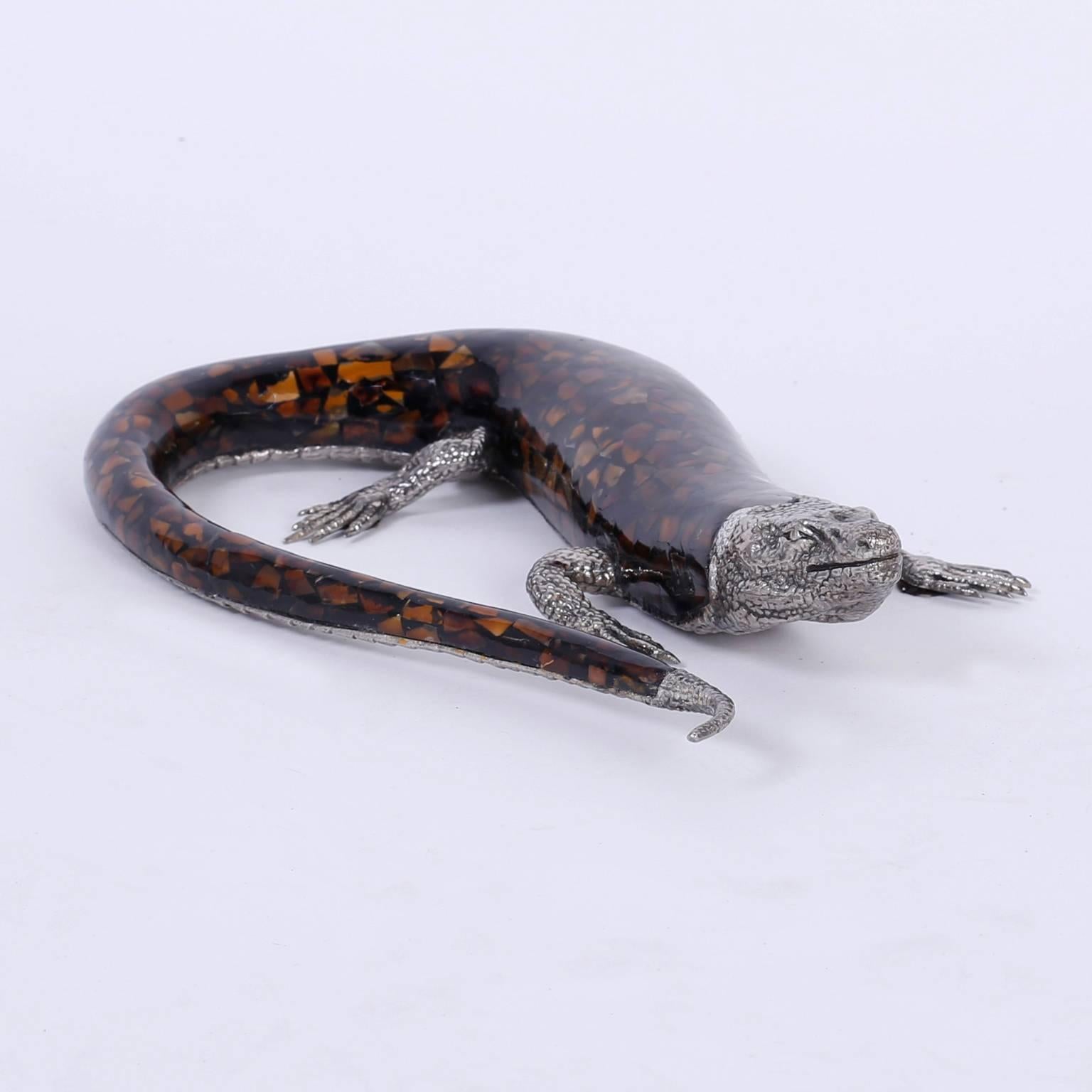 Intriguing midcentury lizard with a lacquered terrazzo body and hand tooled silver metal head, feet, tail tip, and bottom. Signed Maitland-Smith on a gold tag.