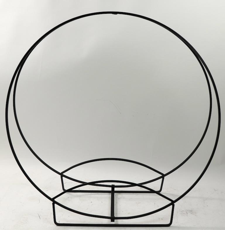Architectural circular log holder of solid stock wrought iron. Freestanding, having two large (38.75 inch diameter) rings, which hold the logs in place. Sturdy and strong construction, clean and ready to use.
