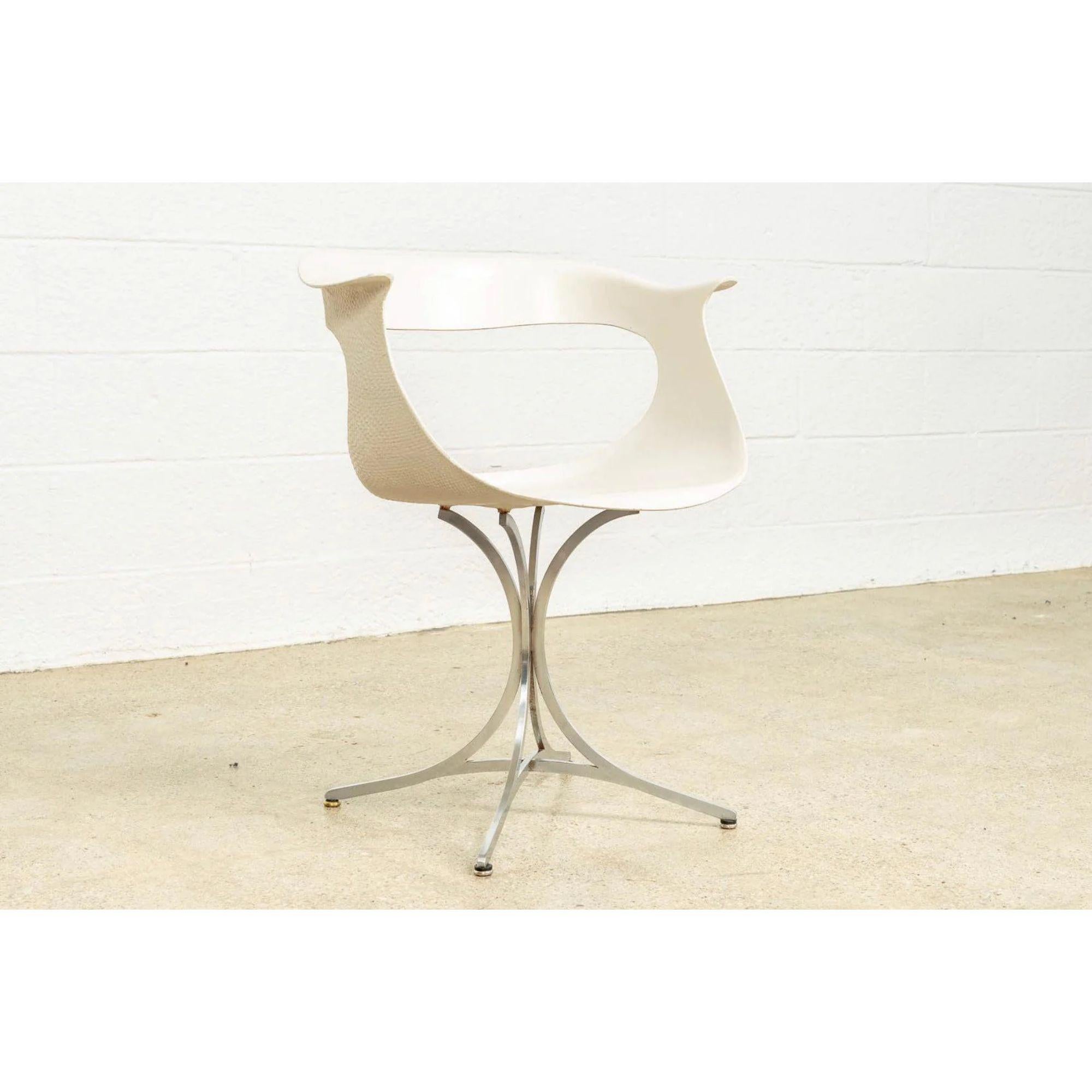 This vintage Mid-Century Modern “Lotus” white on chrome armchair was designed by American husband and wife team Erwine and Estelle Laverne for Laverne International circa 1950. The iconic design features clean lines and elegant curves. The
