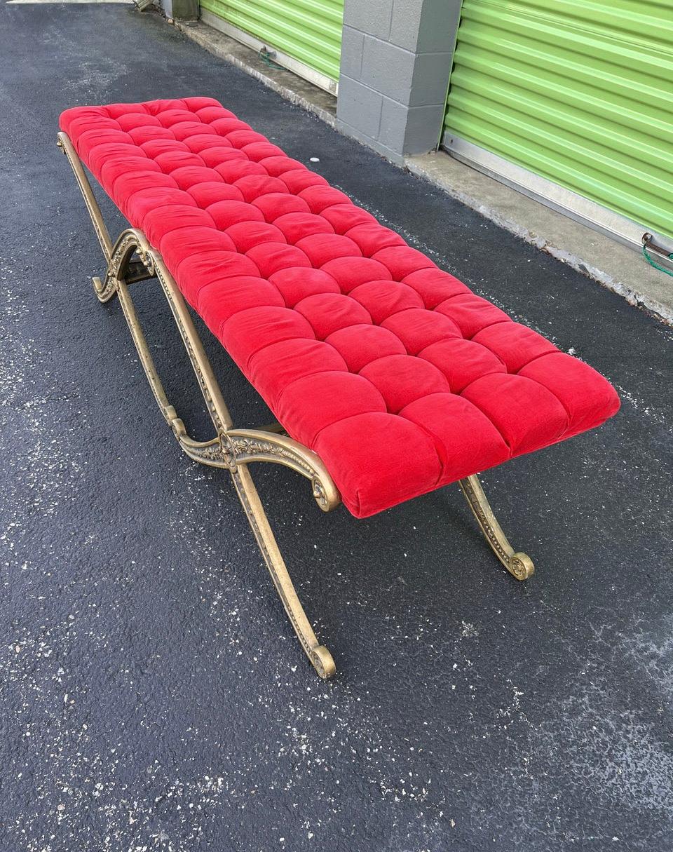 Mid-Century Louis XIV style double X bench, original bright red velvet upholstery, gold frame 
Original label attached.