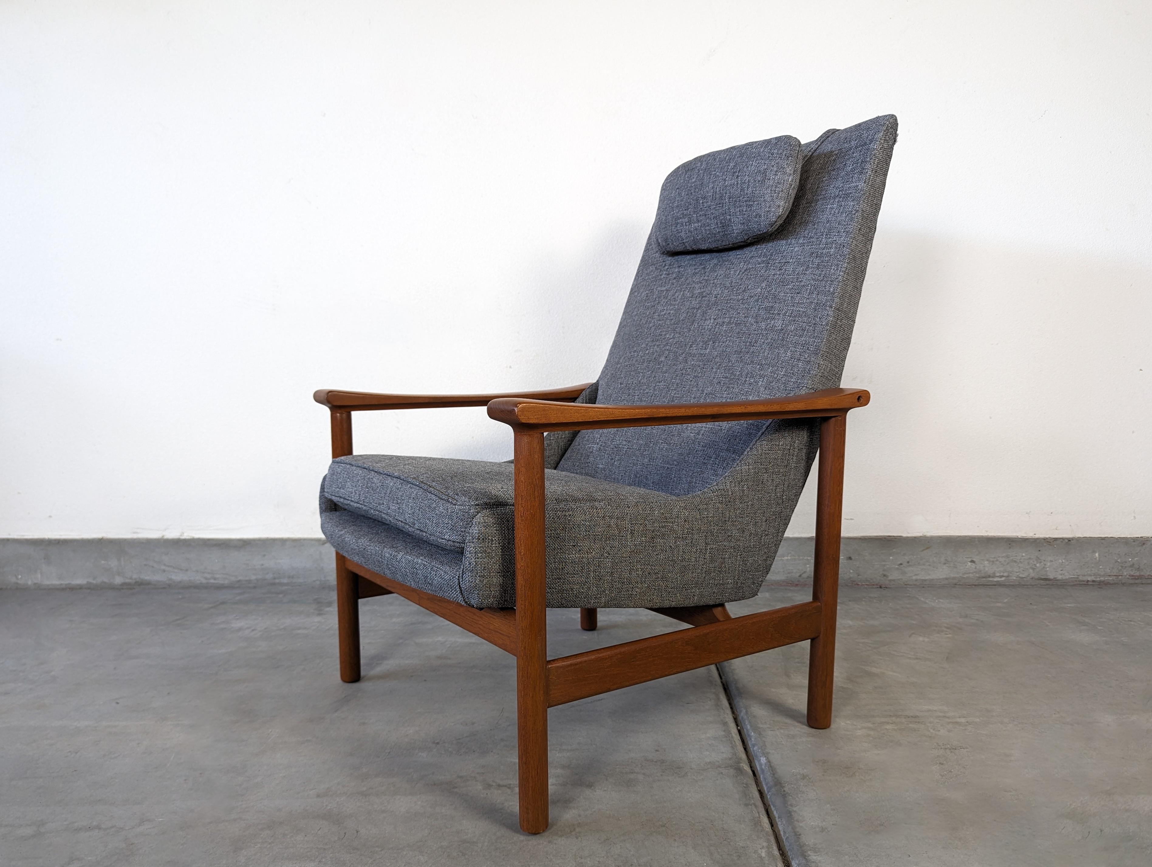 Introducing a timeless piece of Scandinavian design, this Model-251 lounge chair effortlessly combines elegance, comfort, and craftsmanship. With its stunning teak base and newly upholstered gray fabric, this chair is a true statement of style and