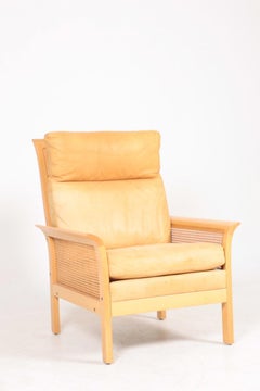 Midcentury Lounge Chair in Patinated Leather and Cane Designed by Arne Norell