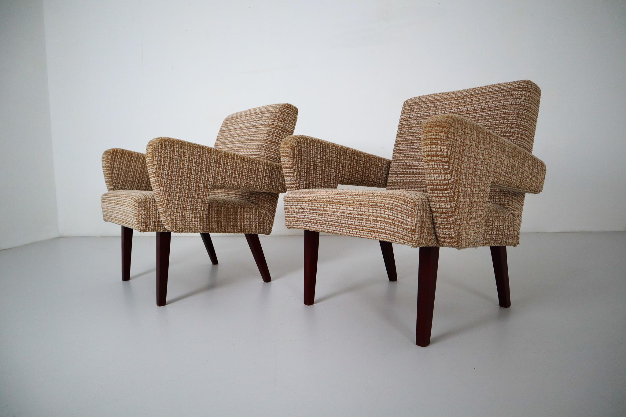 These midcentury lounge chairs are made in Czech Republic, circa 1960. The chairs are in good vintage condition and contains original fabric and beech feet. The fabric have some wear from previous use but remains in very good condition.