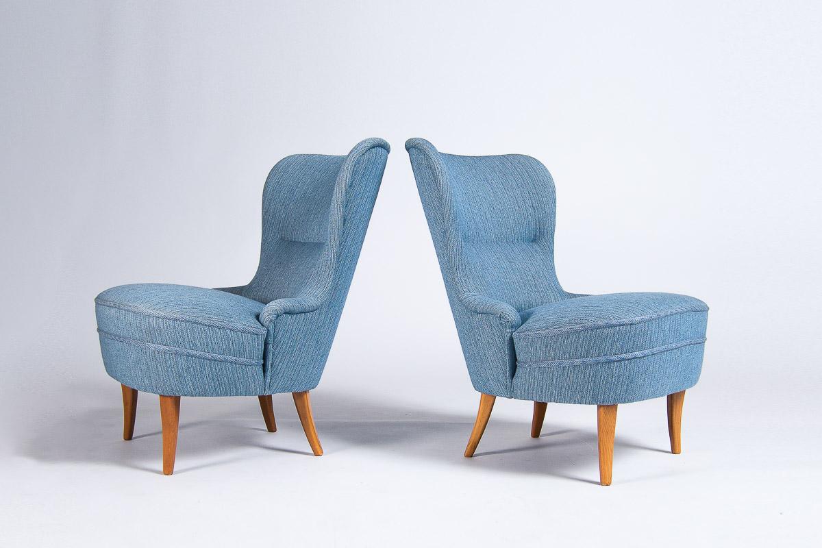 A handsome pair of mid century lounge chairs made by a Swedish cabinetmaker in the 1950’s. Beautiful elegant lines and curves to these petite pair of chairs that exemplify great Scandinavian design . They retain their original blue wool upholstery