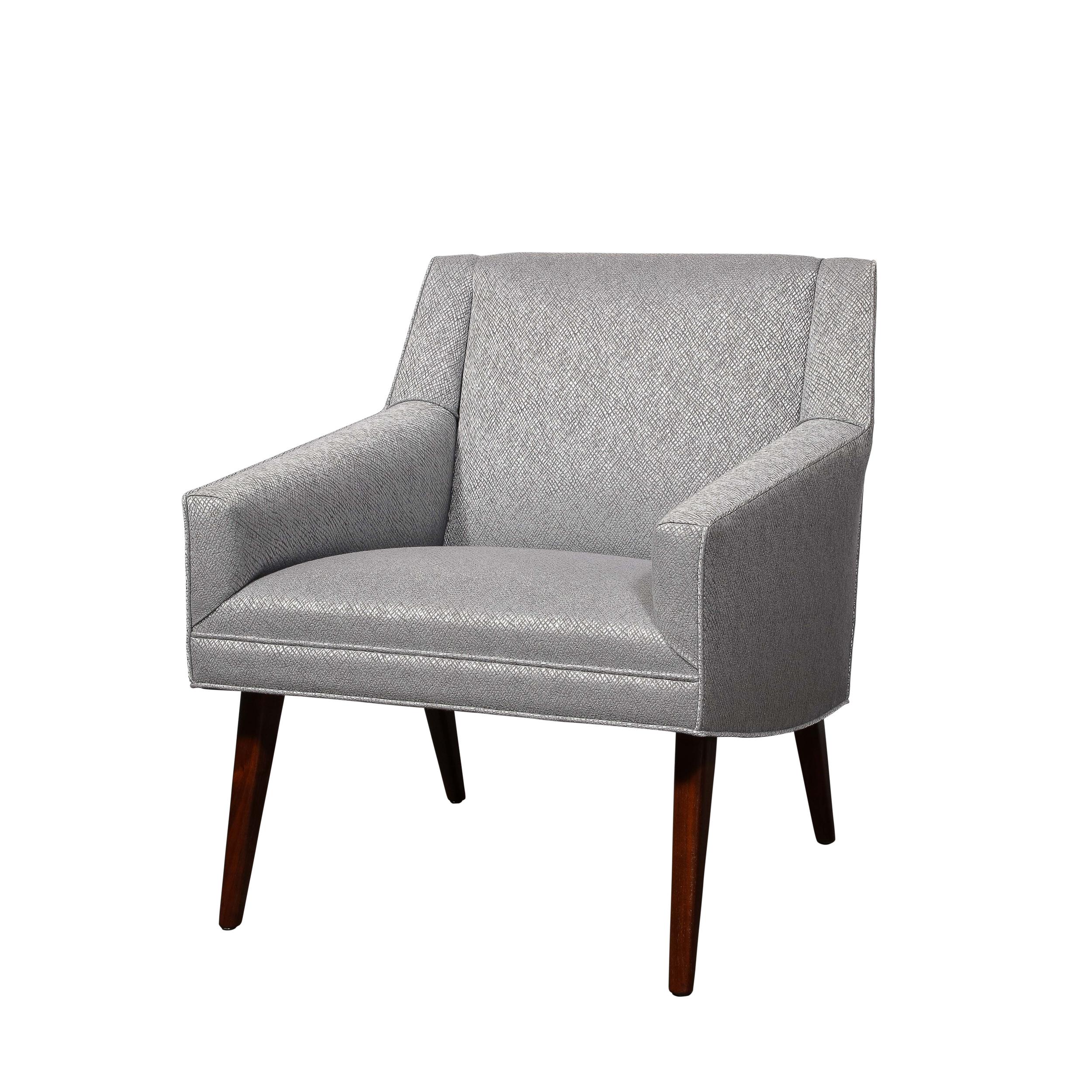 This pair of striking Mid-Century Modernist Lounge Chairs date back to 1960, originating from Denmark. The chairs are beautifully upholstered in a textured silver holly hunt fabric that smoothly contrasts the minimal geometric profile. Versatile and