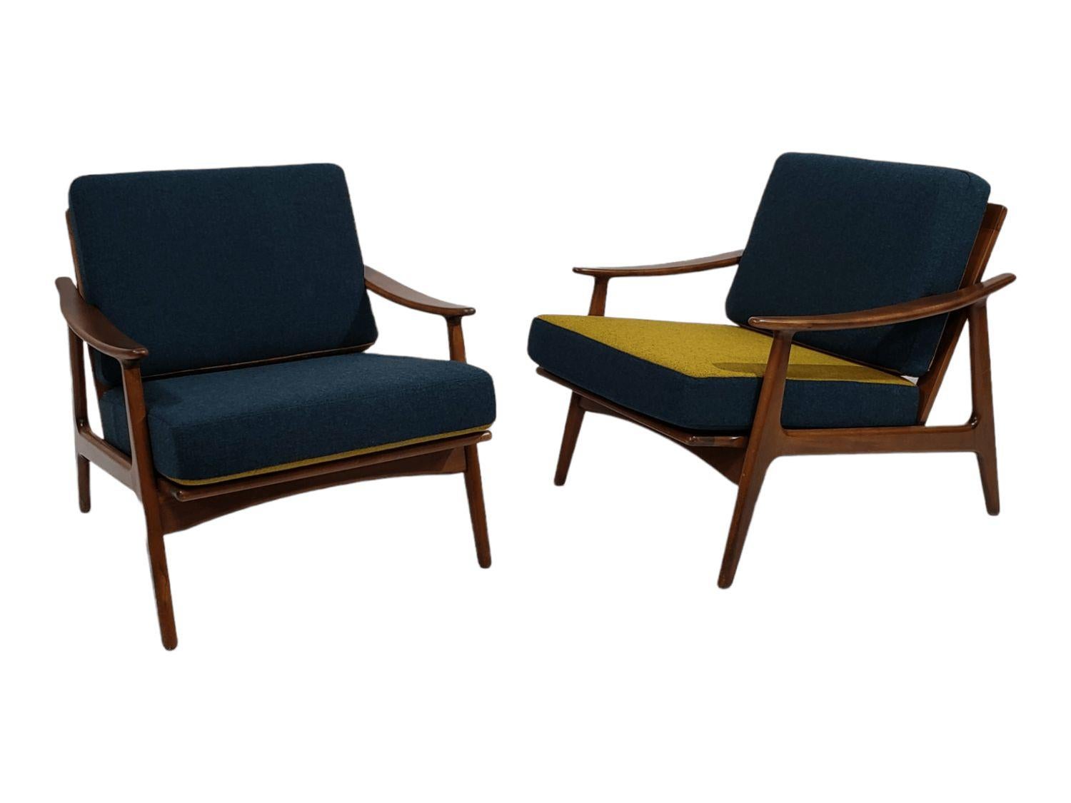 Pair of Danish Modern lounge chairs crafted of stained solid beech frames with sculpted arms, stamped 