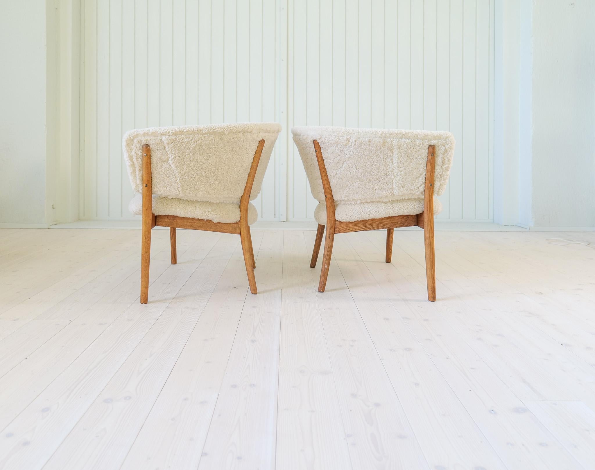 Swedish Mid-Century Lounge Chairs in Sheepskin/Shearling and Stained Wood, Sweden, 1962 For Sale