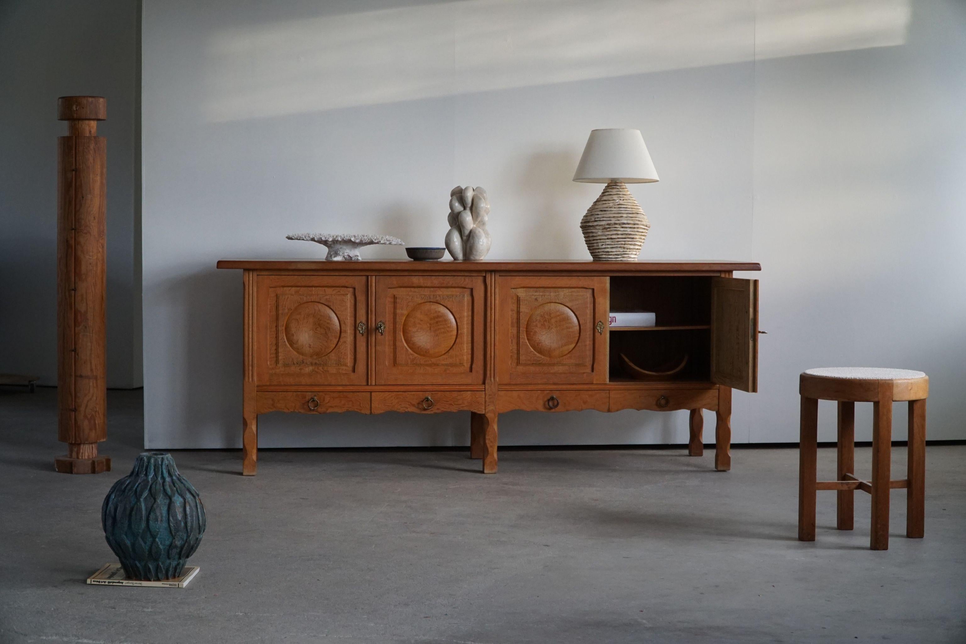 Fantastic low Classic sideboard in solid oak. Made by a Danish Cabinetmaker, Anker Sørensen in 1960s. This piece is in a great vintage condition, with few signs of wear on the surface.

This brutalist object will fit into many interior styles. A