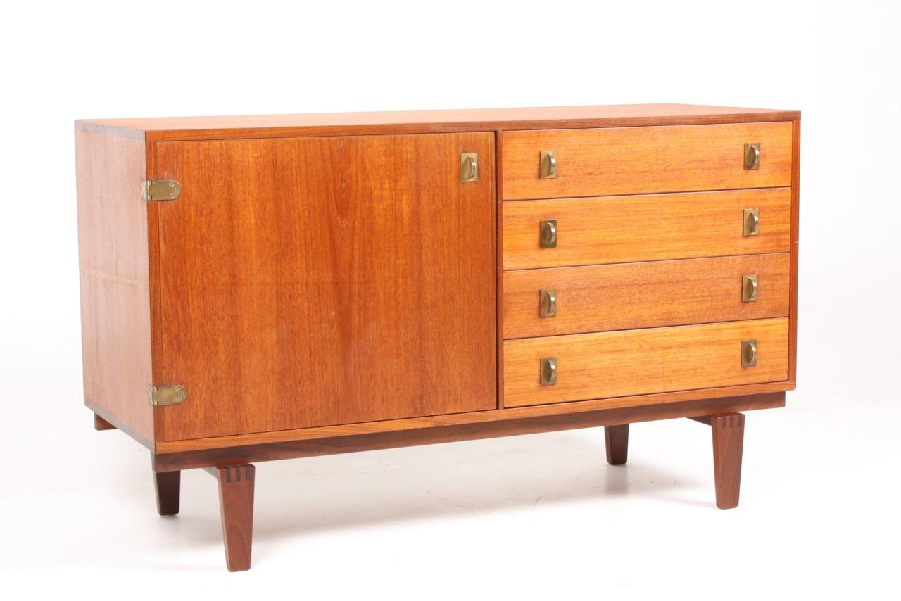 Cabinet in teak with brass hardware. Designed by Peter Løvig Nielsen, Denmark in the 1960s. Great original condition.