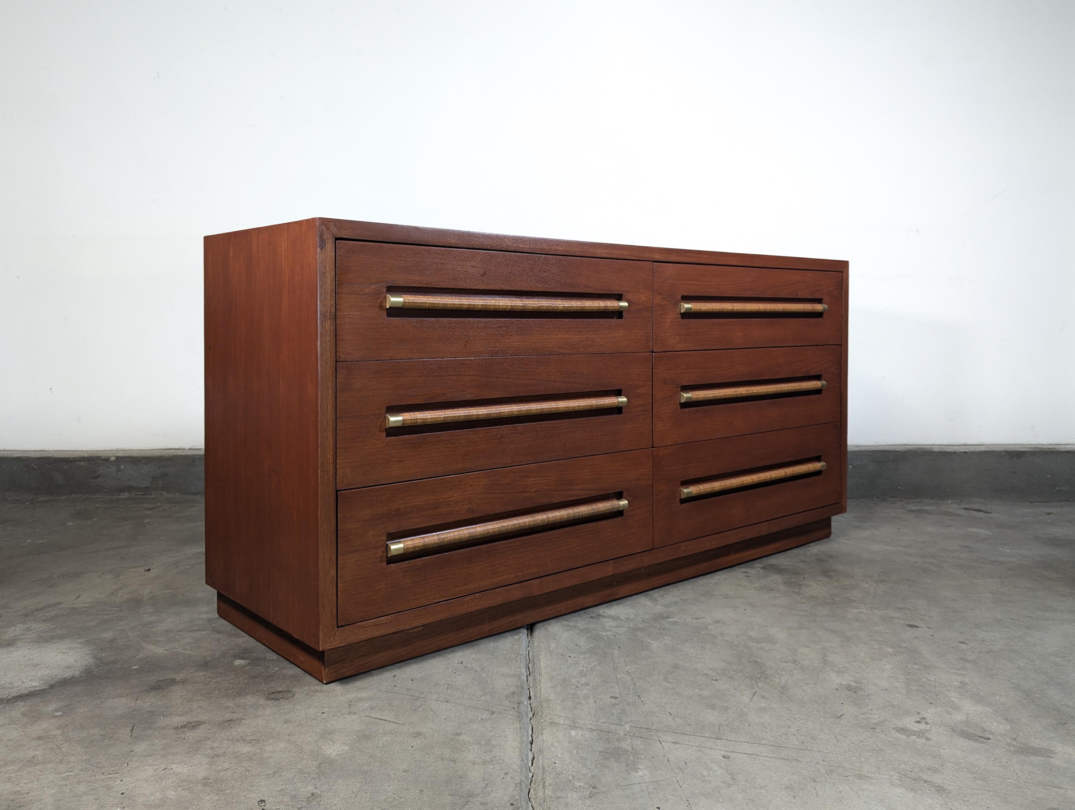 Step into the elegance of the 1960s with this exquisite Vintage Mid Century Lowboy Dresser by Morganton, a true testament to the timeless craftsmanship of its era. Measuring approximately 61 inches wide, 20 inches deep, and standing 31.75 inches
