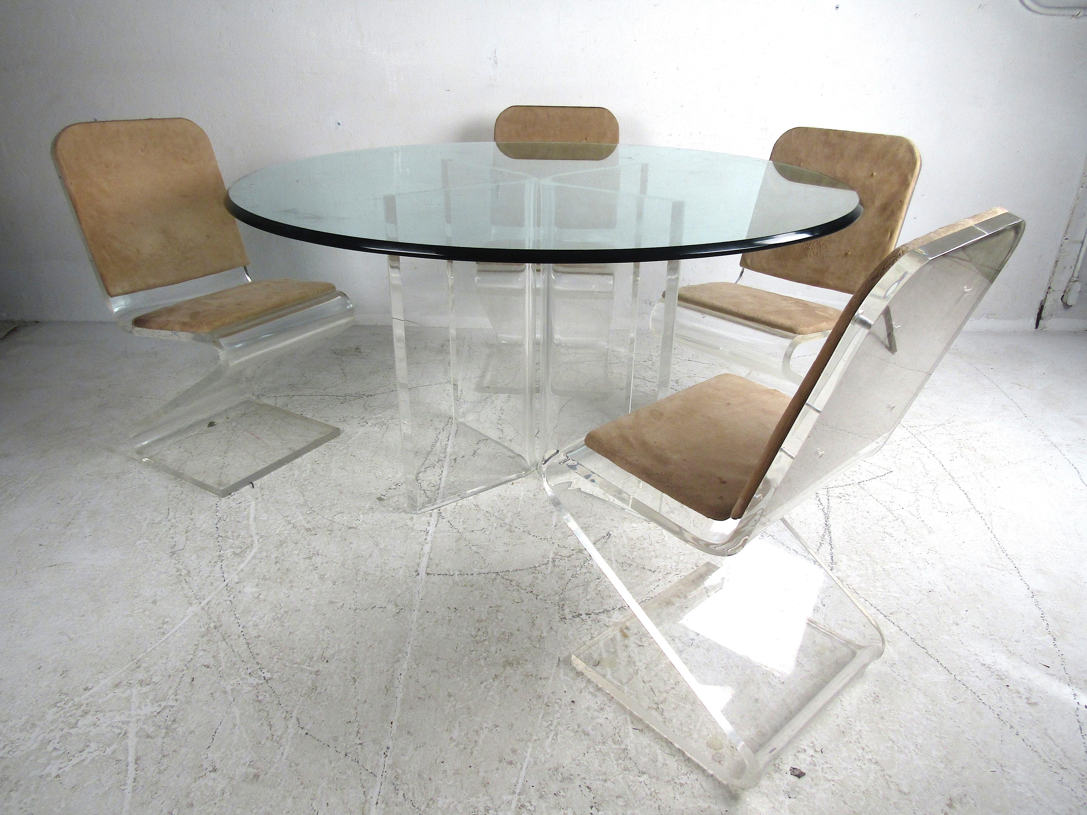 Stylish Mid-Century Modern Lucite and glass dining set. Large circular glass tabletop with adjustable Lucite bases. Set of 4 dining chairs with Lucite 