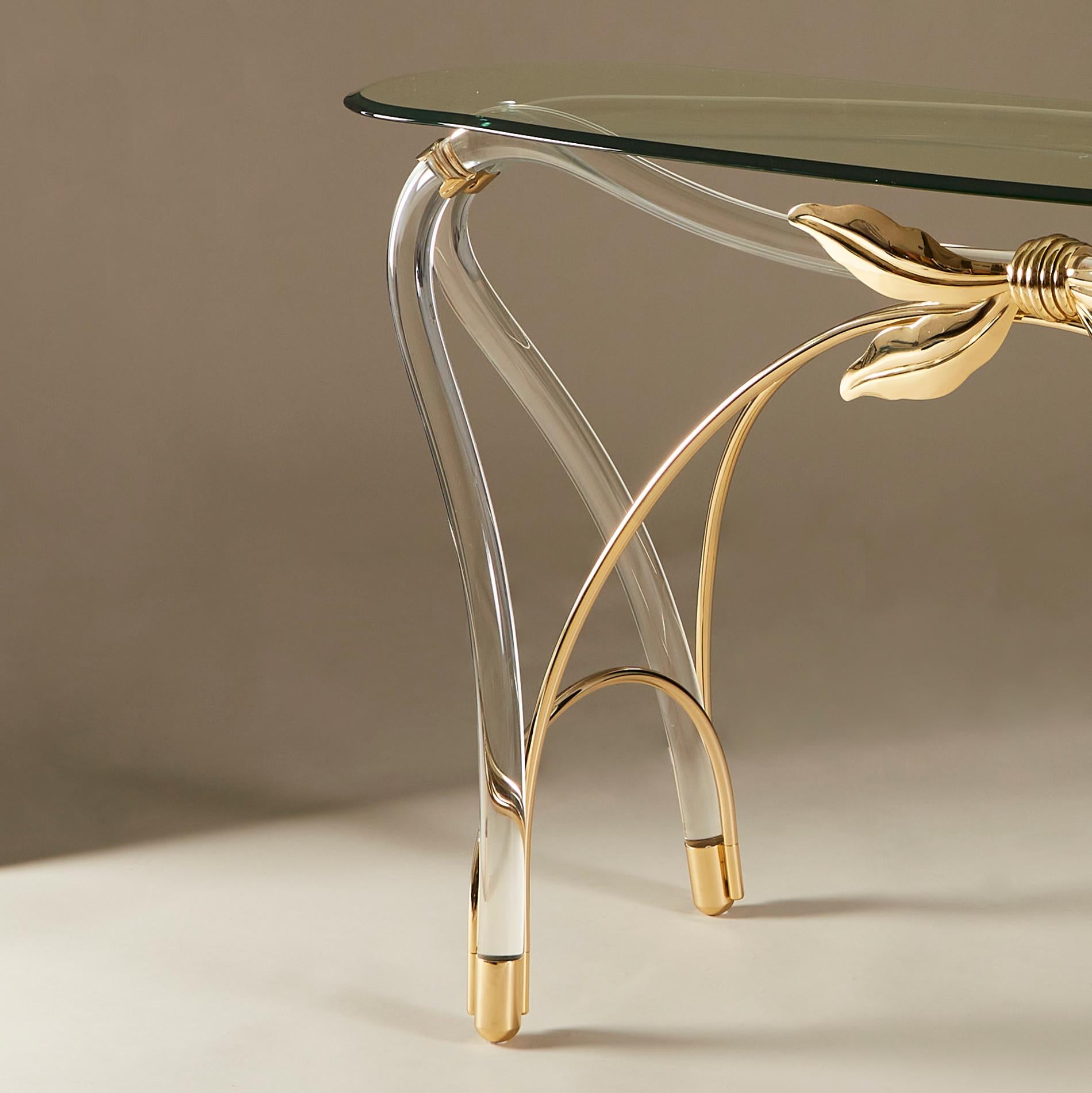 Elegant well proportioned 1970s console table in the style of Jeff Messerschmidt. Unusual curved Lucite shapes form both the base and legs of the piece. A large decorative gold metal bow enhances the design with more gold detailing extending down to