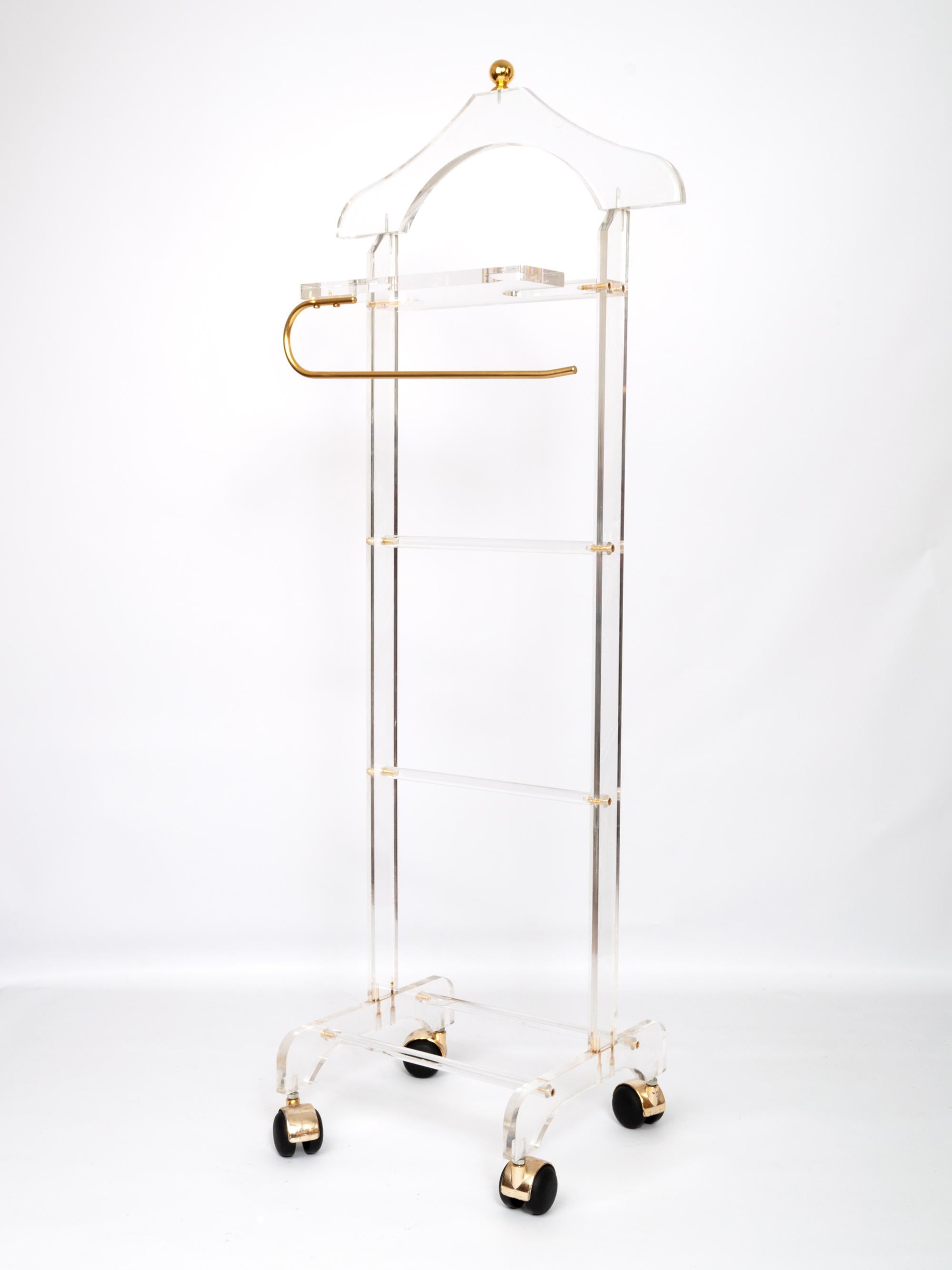Midcentury Lucite and brass valet stand on castors, Italy, circa 1960.
In very good vintage condition commensurate of age.