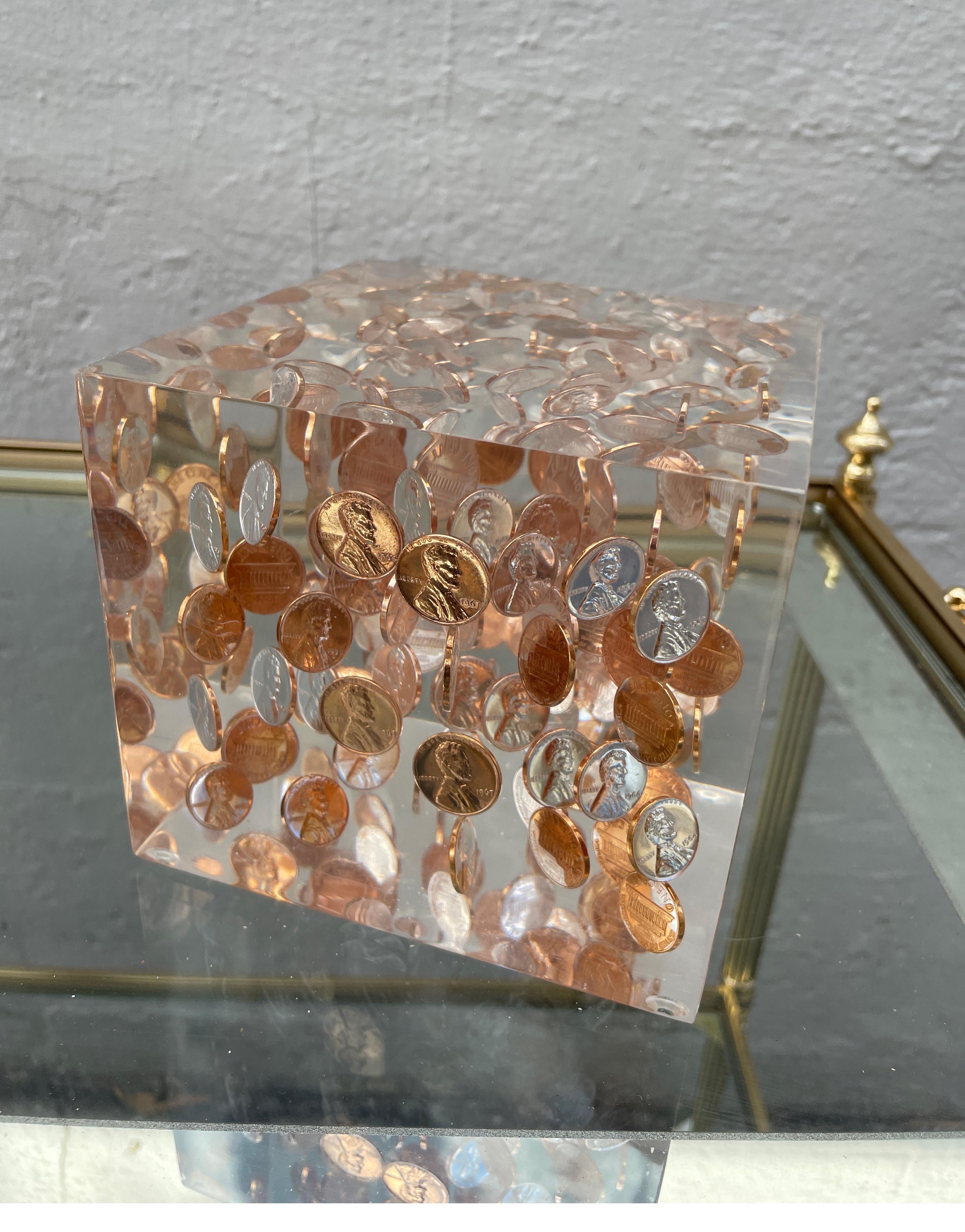 Mid-Century Modern large lucite cube filled with floating copper pennies. A great accent piece.