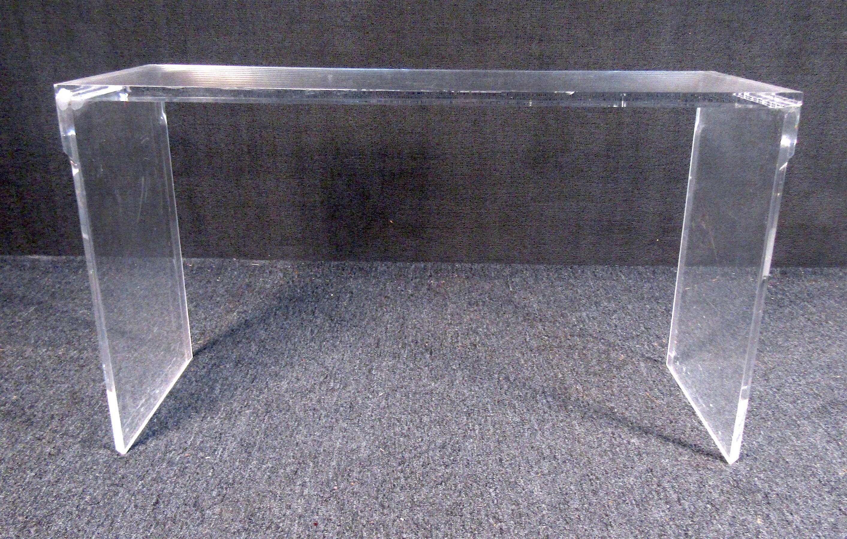 An unusual vintage modern rectangle console table featured in lucite. It is a sure eye-grabber for any modern entryway and sure to be a conversation starter. Please confirm item location with dealer (NJ or NY).