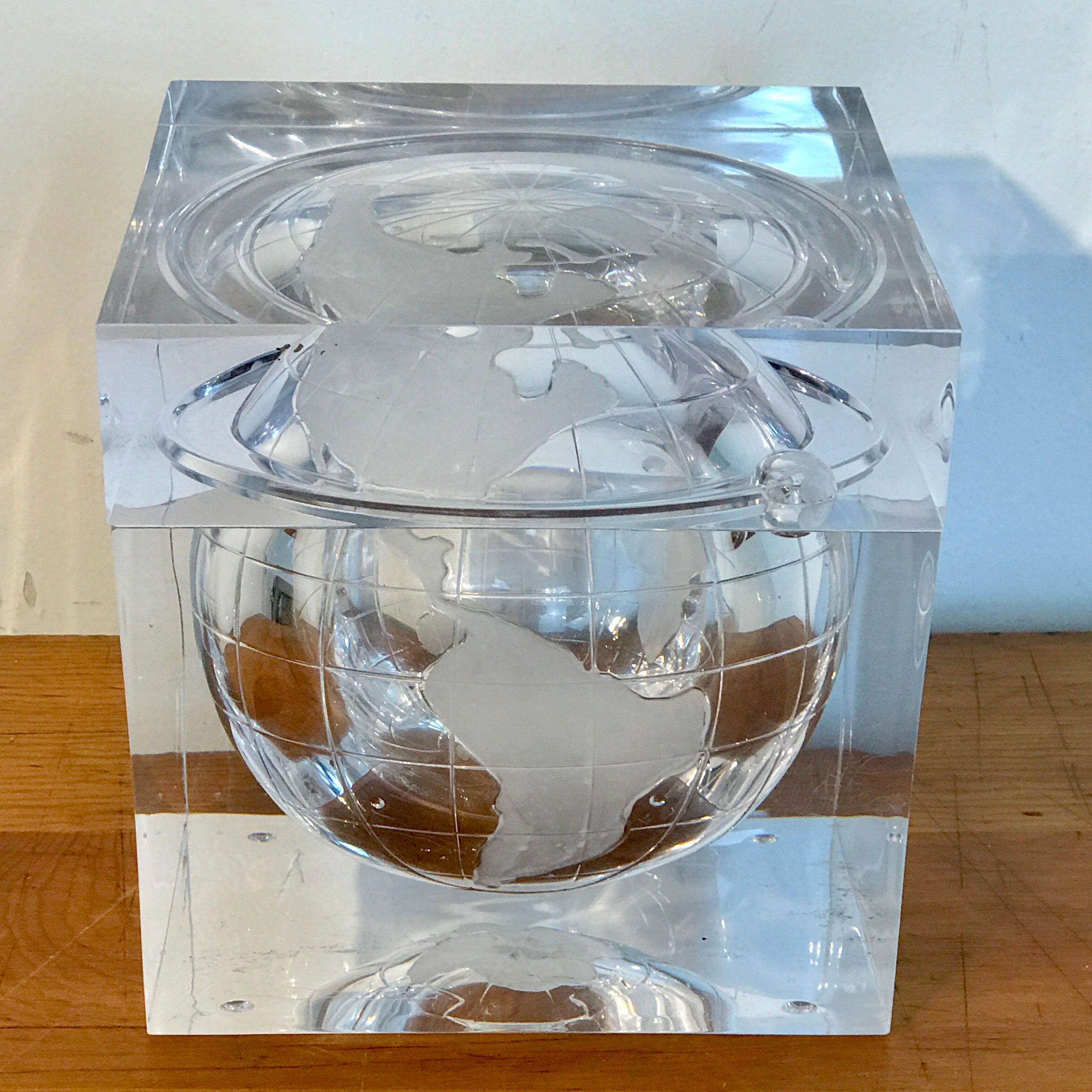 Midcentury Lucite globe ice bucket, in two parts with a removable top revealing a 5 x 5 inch interior
Depicting the earth and sun.