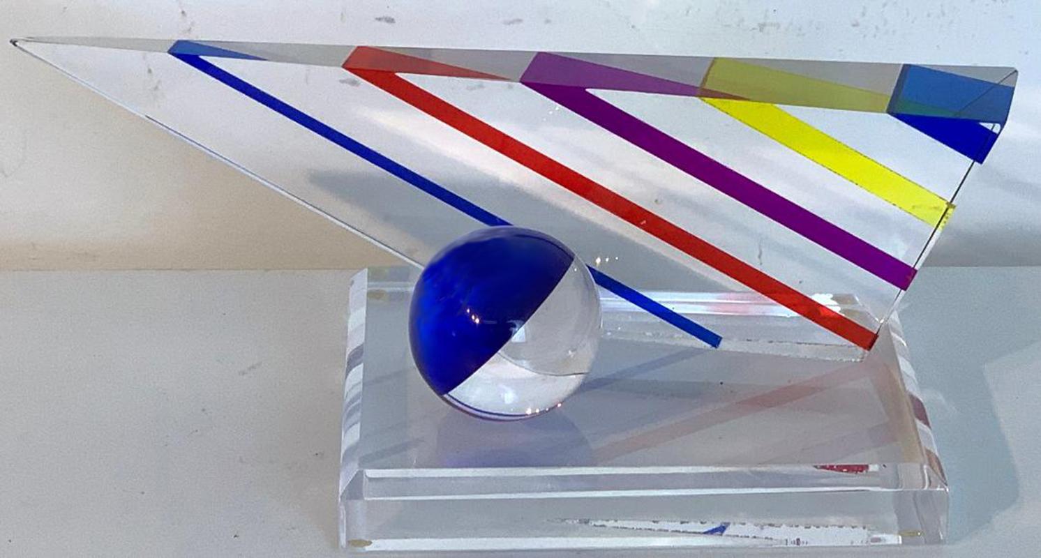 Midcentury lucite multicolored triangular geometric sculpture by will grant, a horizontal triangle with rainbow colors, with a half cobalt and clear sphere raised on a rectangular 6