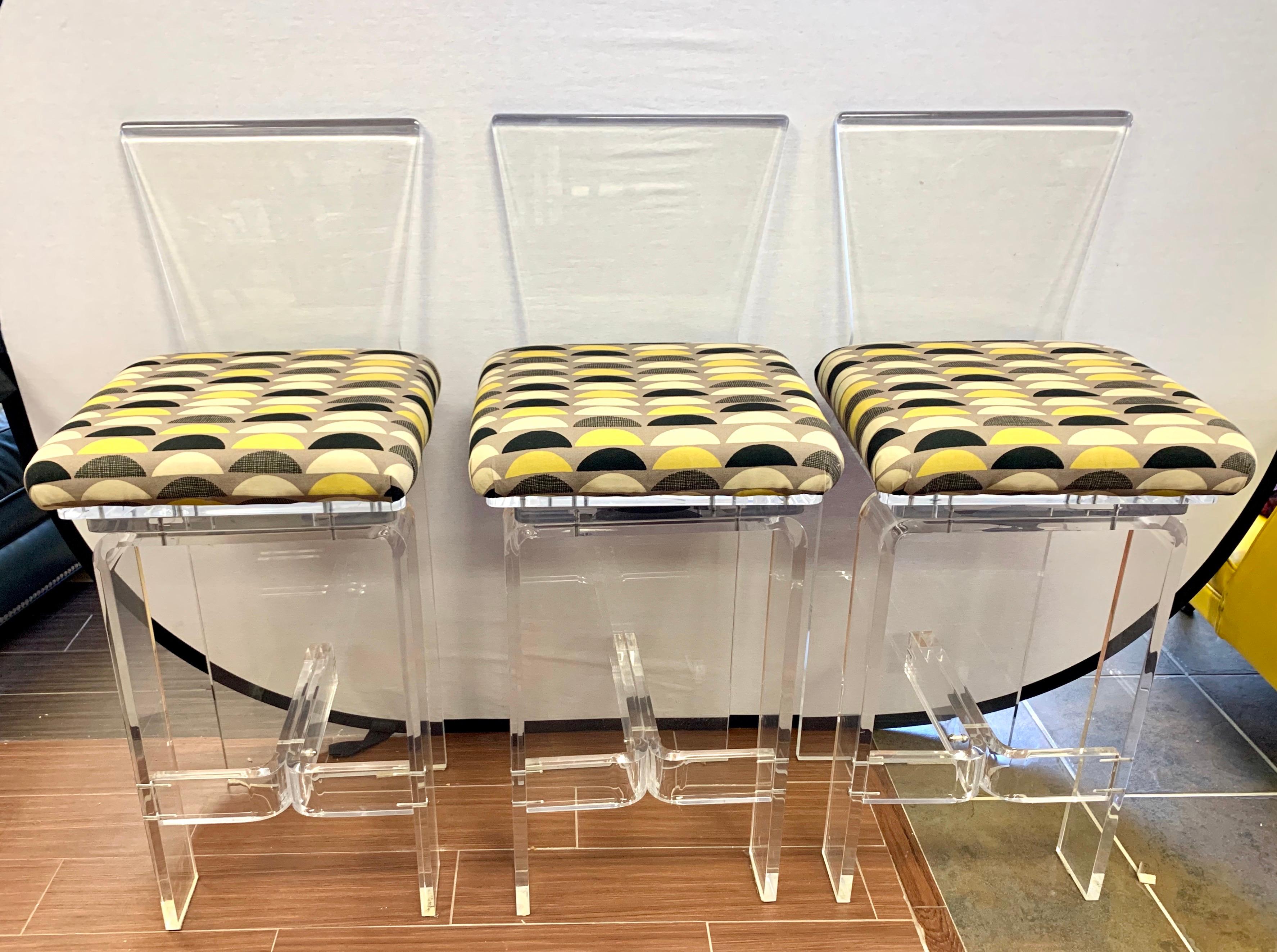 Magnificent set of newly upholstered heavy Lucite swivel chairs, circa 1970s and made in the USA. Each chair weighs forty pounds and has brand new Herman Miller upholstery. Seat height is 29 inches and all other dimensions are below.