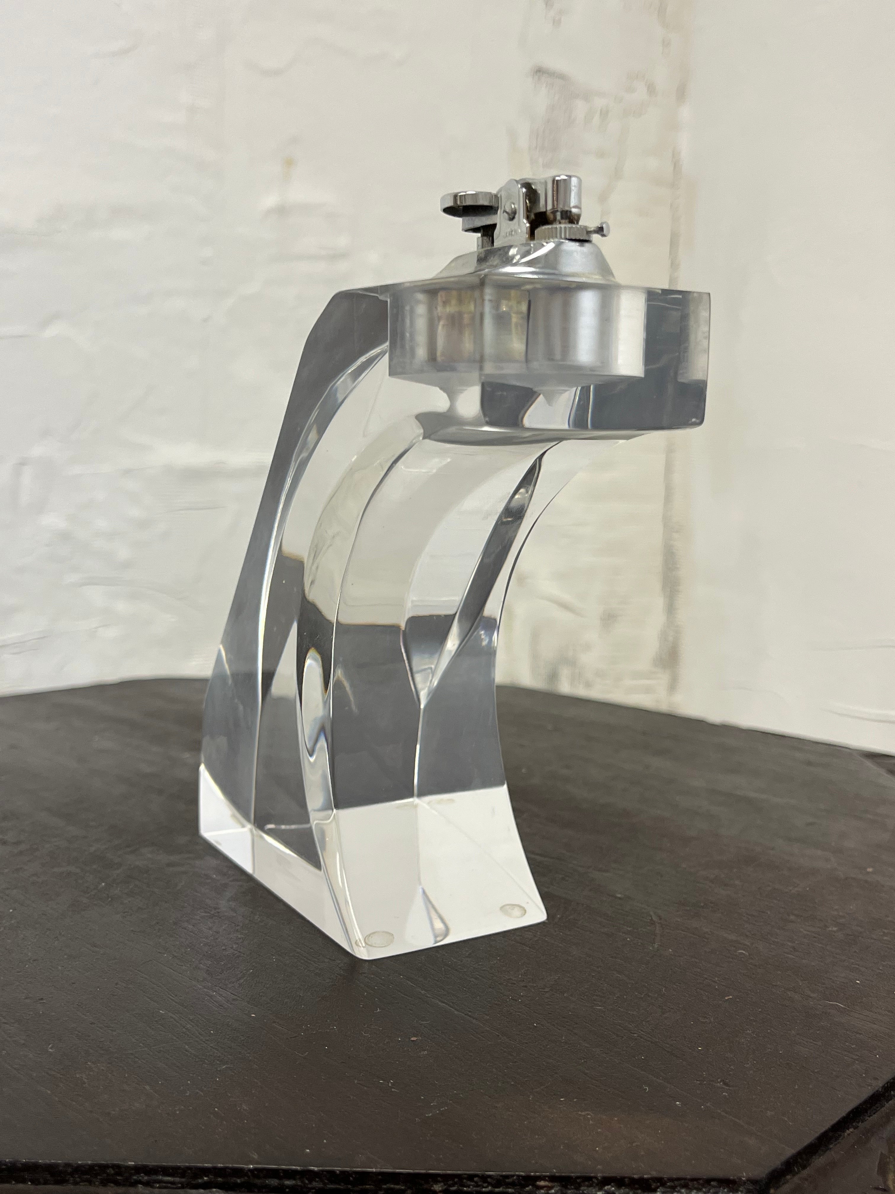 Great table lighter. Lucite form in an inviting design. Does't appear to have been used. 