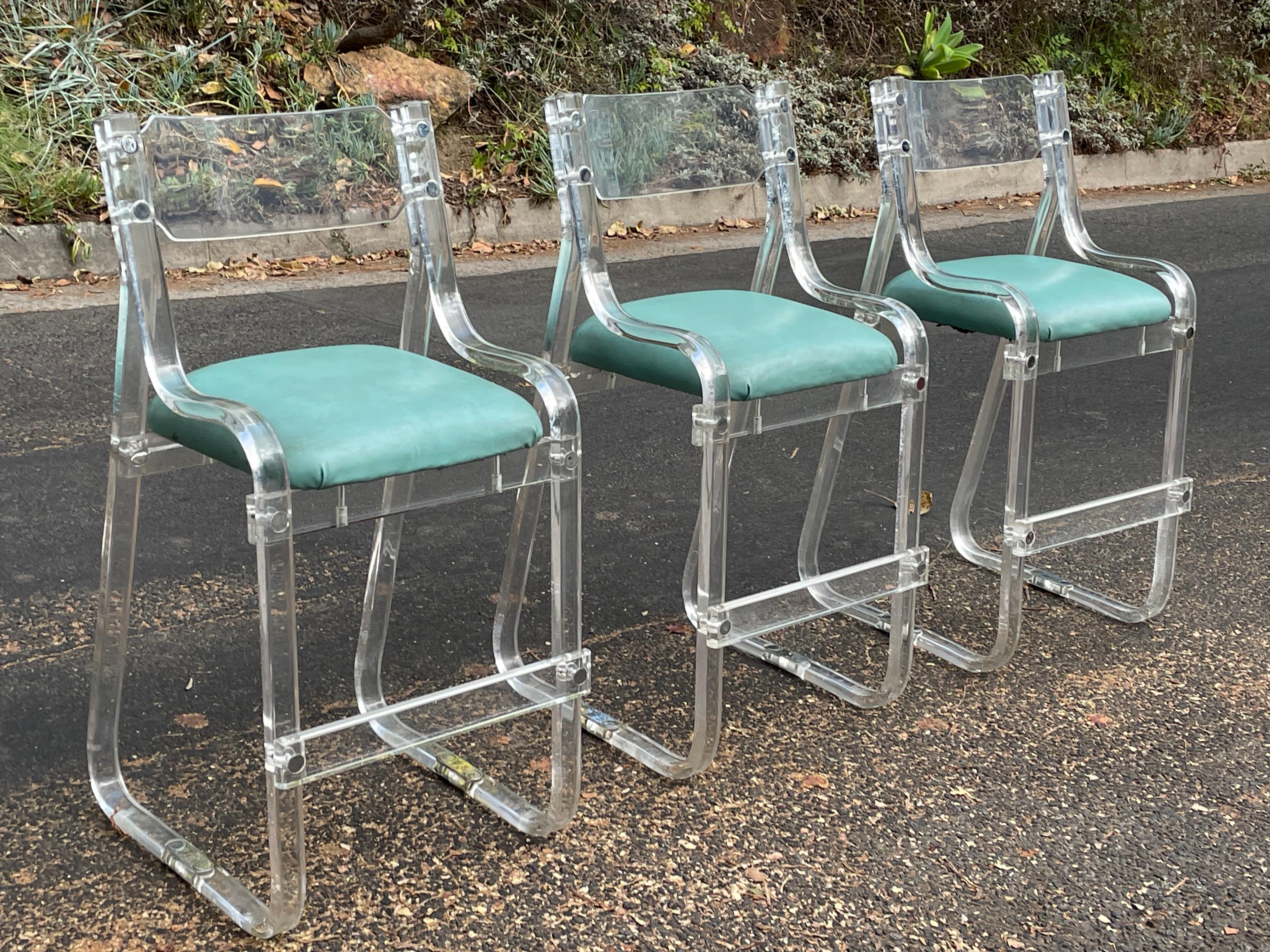 Set of rare 1960s Charles Hollis Jones lucite bar stools with turquoise cushions and chrome detail.

This a tremendous set of designer bar stools featuring solid heavy lucite with chrome.

Price is for for the set of three.

The original turquoise