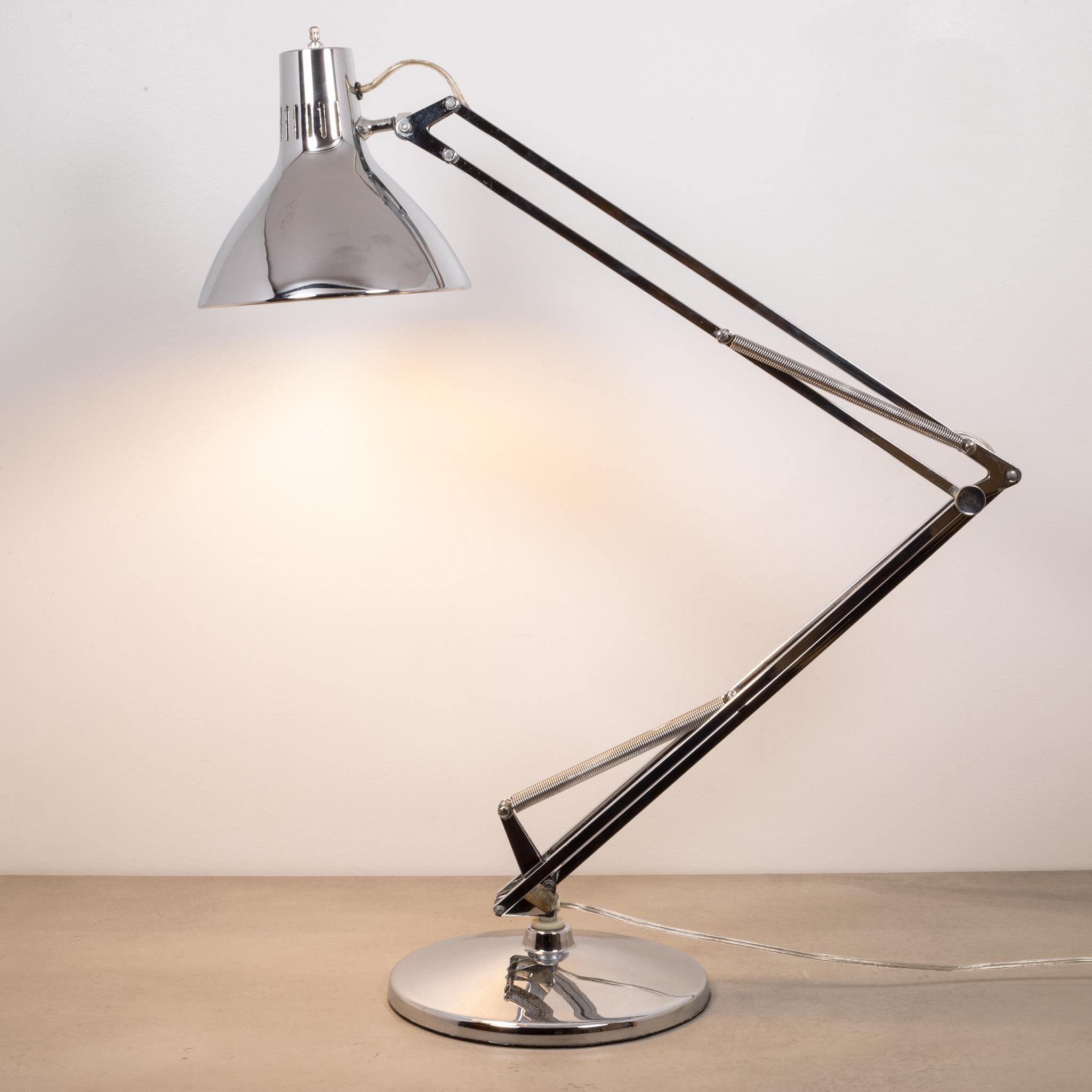 About:

This is an original Luxo articulated, chrome desk lamp. This lamp was originally designed in 1937 by Jac Jacobsen and it's classic design still looks modern today. The shade has an inner plastic shade. This piece has retained its original