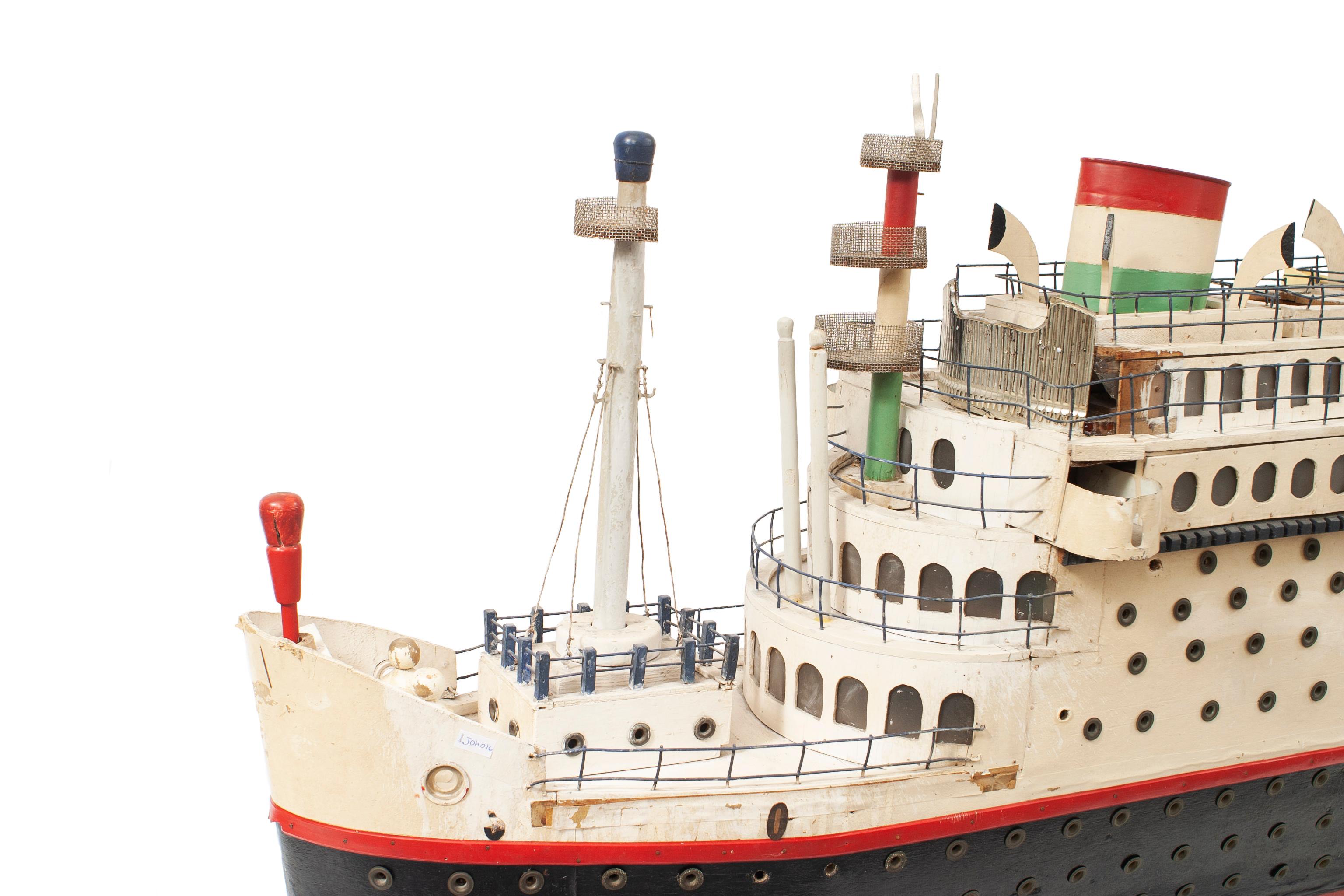 Mid-century model of a luxury liner boat / ship model painted red, white and blue with 2 smoke stacks supported on a stand.