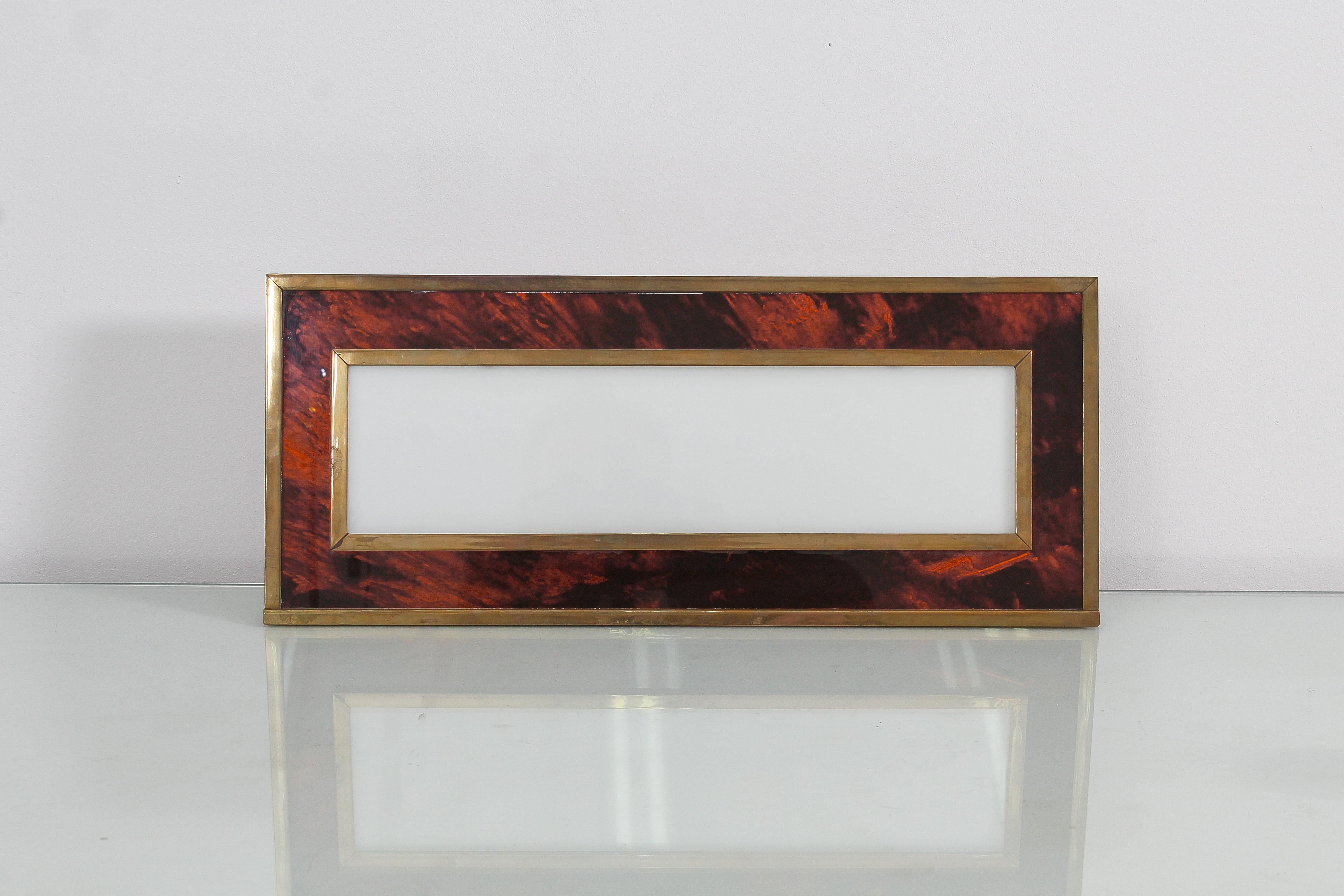 Elegant rectangular photo frame in Lucite and brass. The texture of the polymeric material recalls the turtle. Base support in brass. Attributable to Romeo Rega, Italia 1970. Wear consistent with age and use.