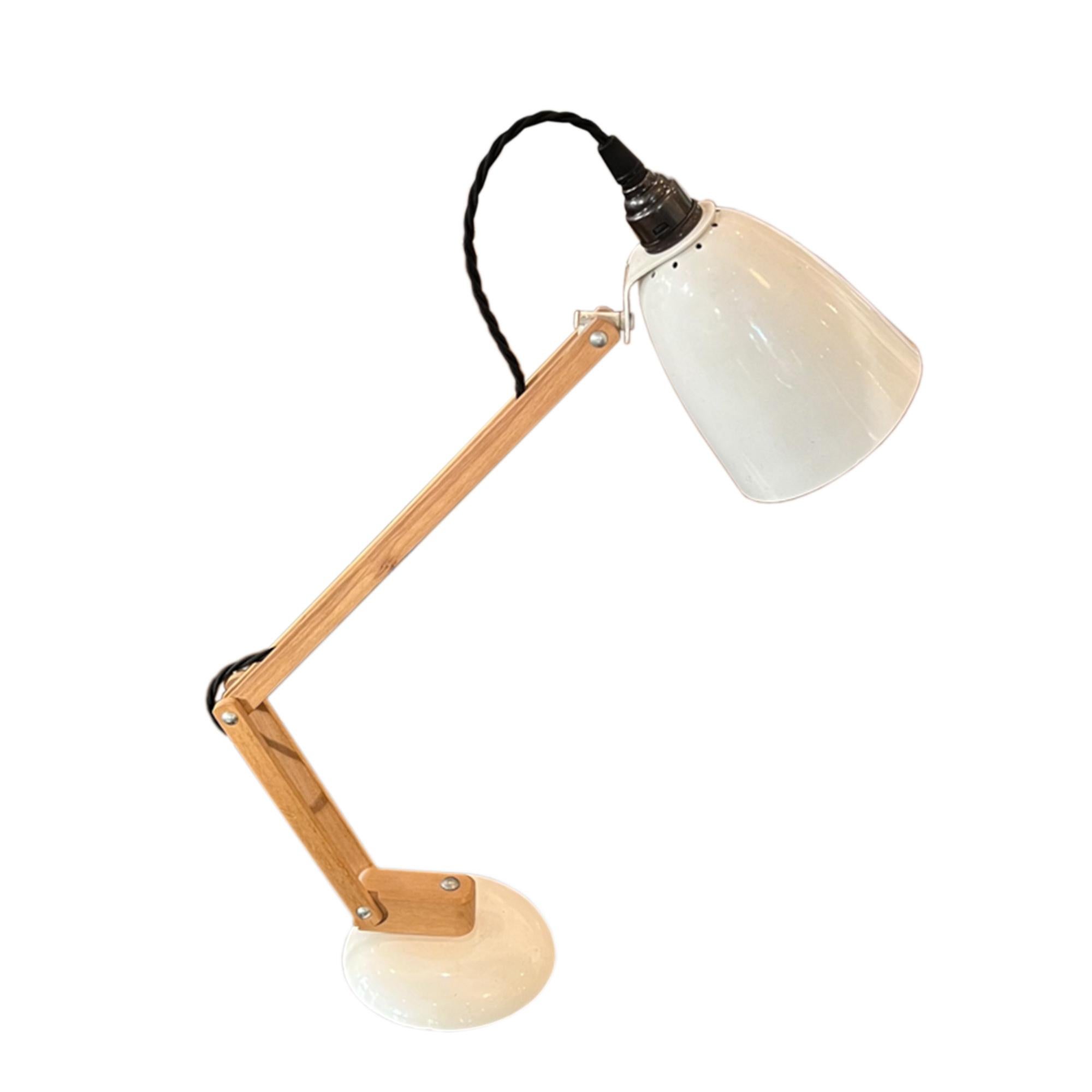 Designed by Terence Conran in Britain in the 1960s, this stylish desk lamp is perfect for working from home, or a bedside light.

Fully adjustable and made from wood and metal. This lamp is in great condition and we've had it rewired using black