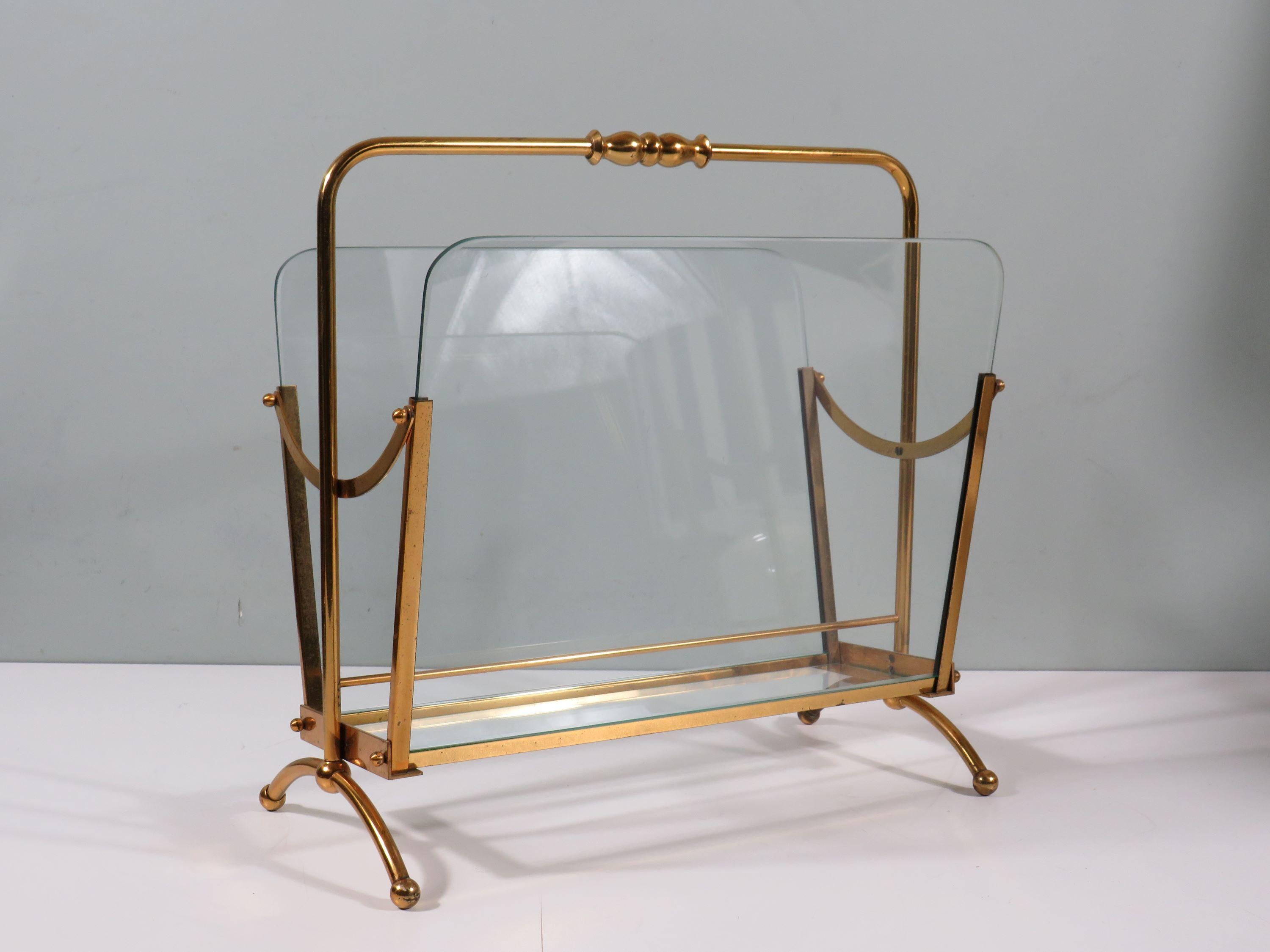 Very elegant magazine rack in brass and cut thick transparent glass with rounded corners.