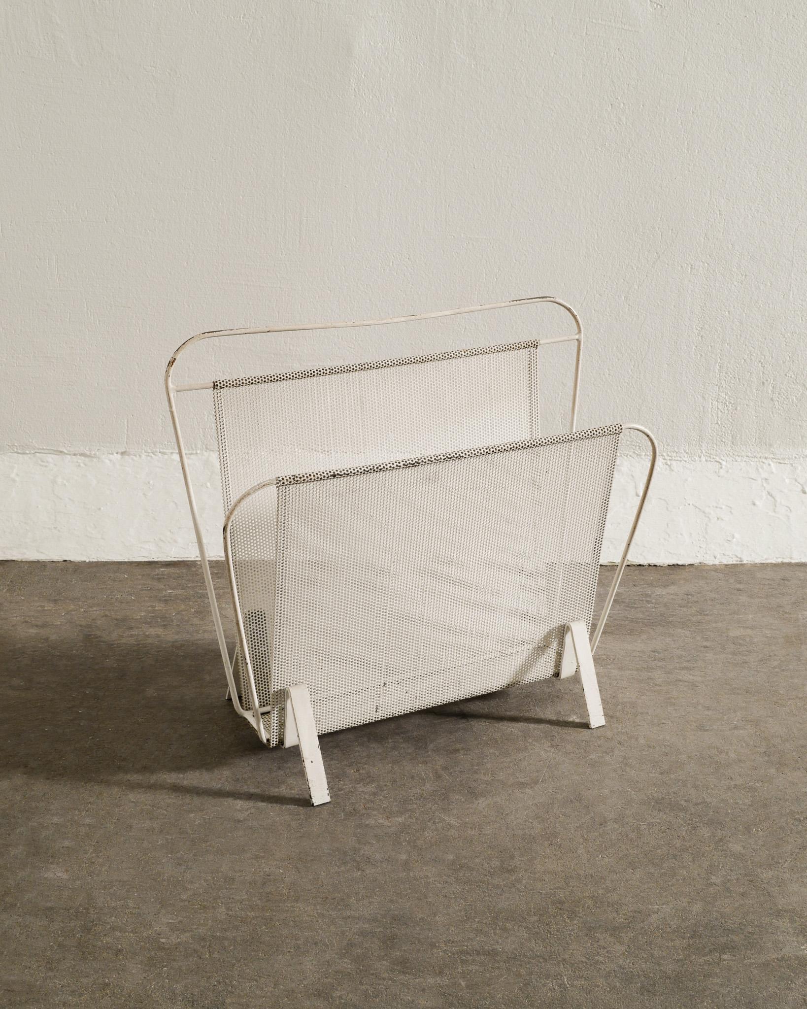 Rare mid century white magazine rack designed by Mathieu Matégot produced in France during the 1950s. In good original condition. 

Dimensions: H: 14.57 in (37 cm) W: 15.75 in (40 cm) D: 5.52 in (14 cm)