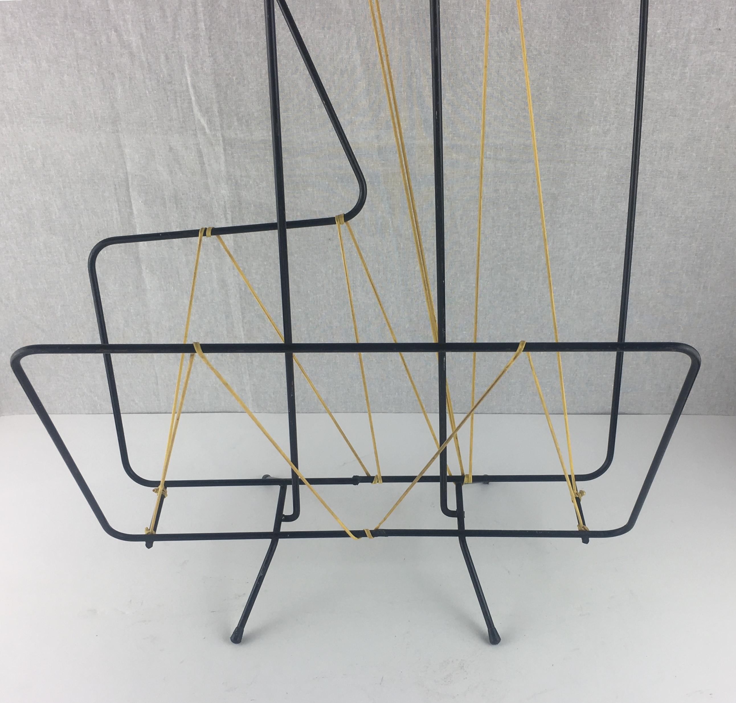 This vintage magazine or newspaper rack was produced in the 1960s.

Very good condition — This item has no defects, but it may show slight traces of use. Patina consistent with age and use.

Materials: Metal
Color Black and yellow
Measures: