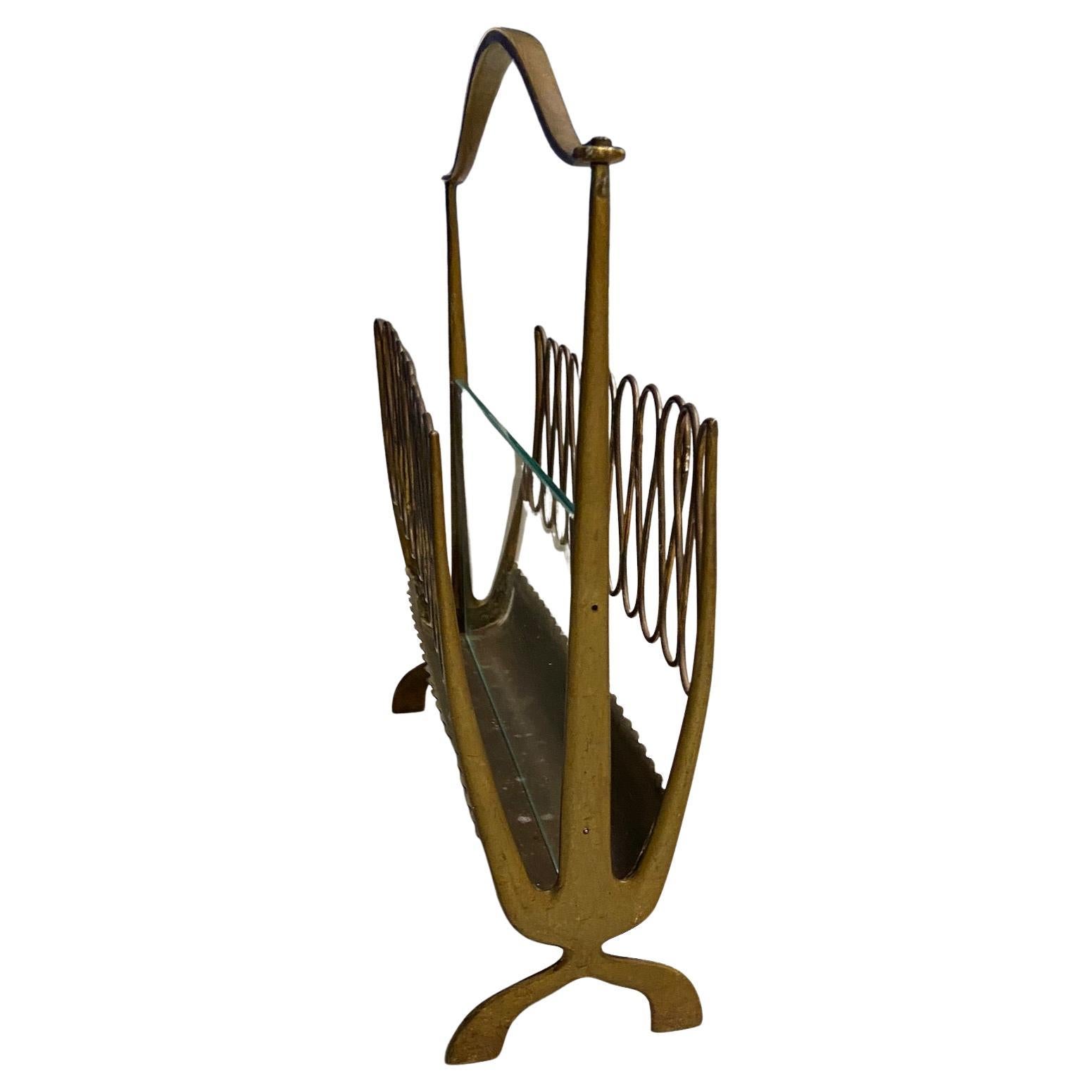 Midcentury magazine rack in the style of Gio Ponti, brass and glass, unpolished.