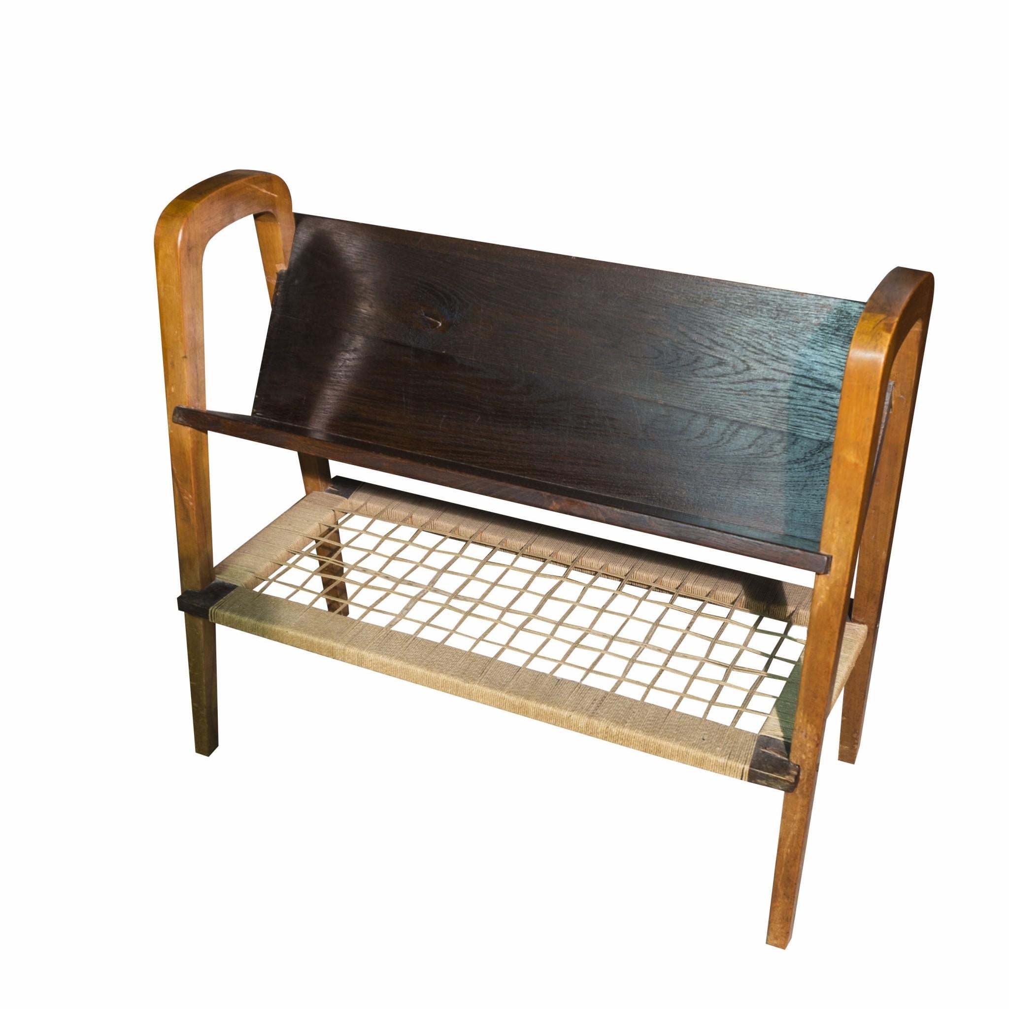 Lovely wooden magazine stand or rack, dating to the 1940s. Solid wood, intertwined bottom part

Attribute to Ladislav Bartonicek or circle, “Krásná Jizba-Druzstevni prace, Praha(Prague)”. In good vintage condition, traces of wear and tear