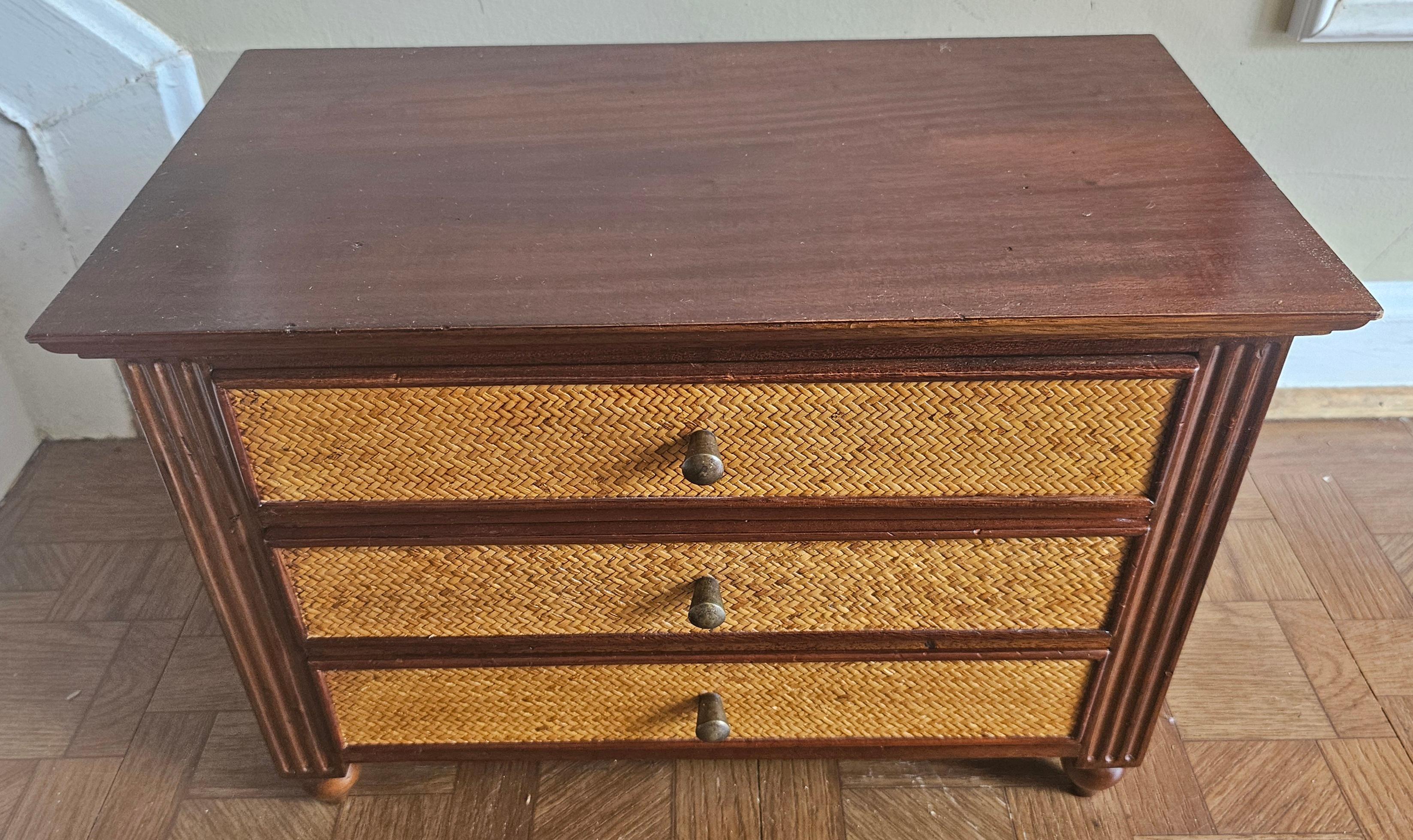 A Mid 20th Century Mahogany and woven grassclothe Jewelry Box with bobbing legs and brass drawer knobs. Measures 16