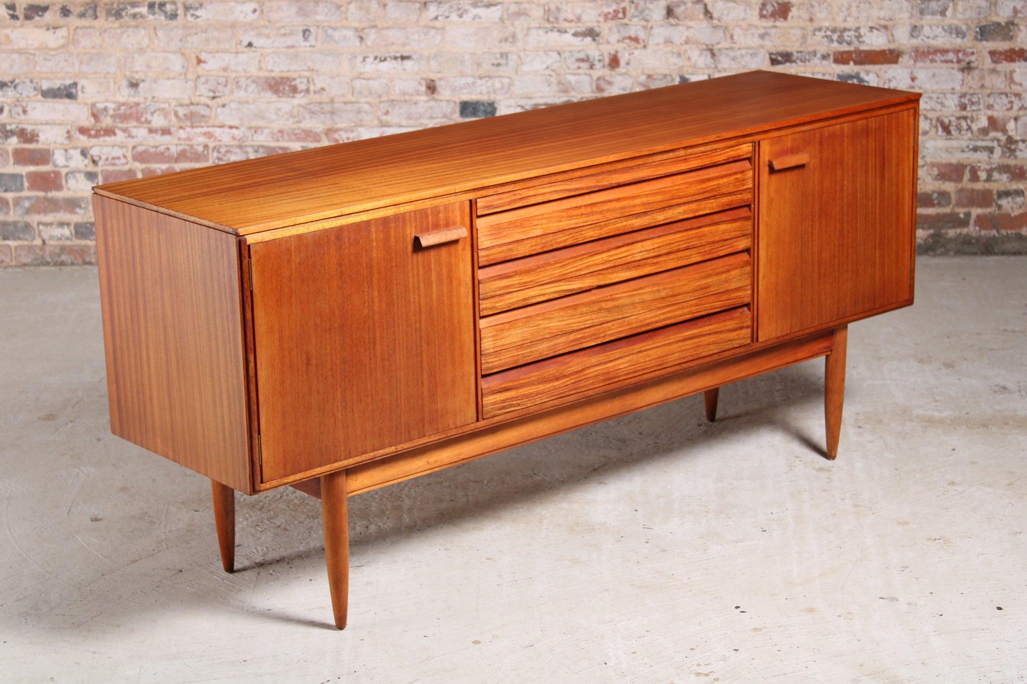 Mid-century mahogany and rosewood sideboard by White & Newton, Portsmouth, circa 1950s. 2 cabinet sections with shelves and 4 drawers with solid rosewood fronts. Top drawer has a cutlery section.

Dimension: W 168 cm x D 46 cm x H 76 cm.