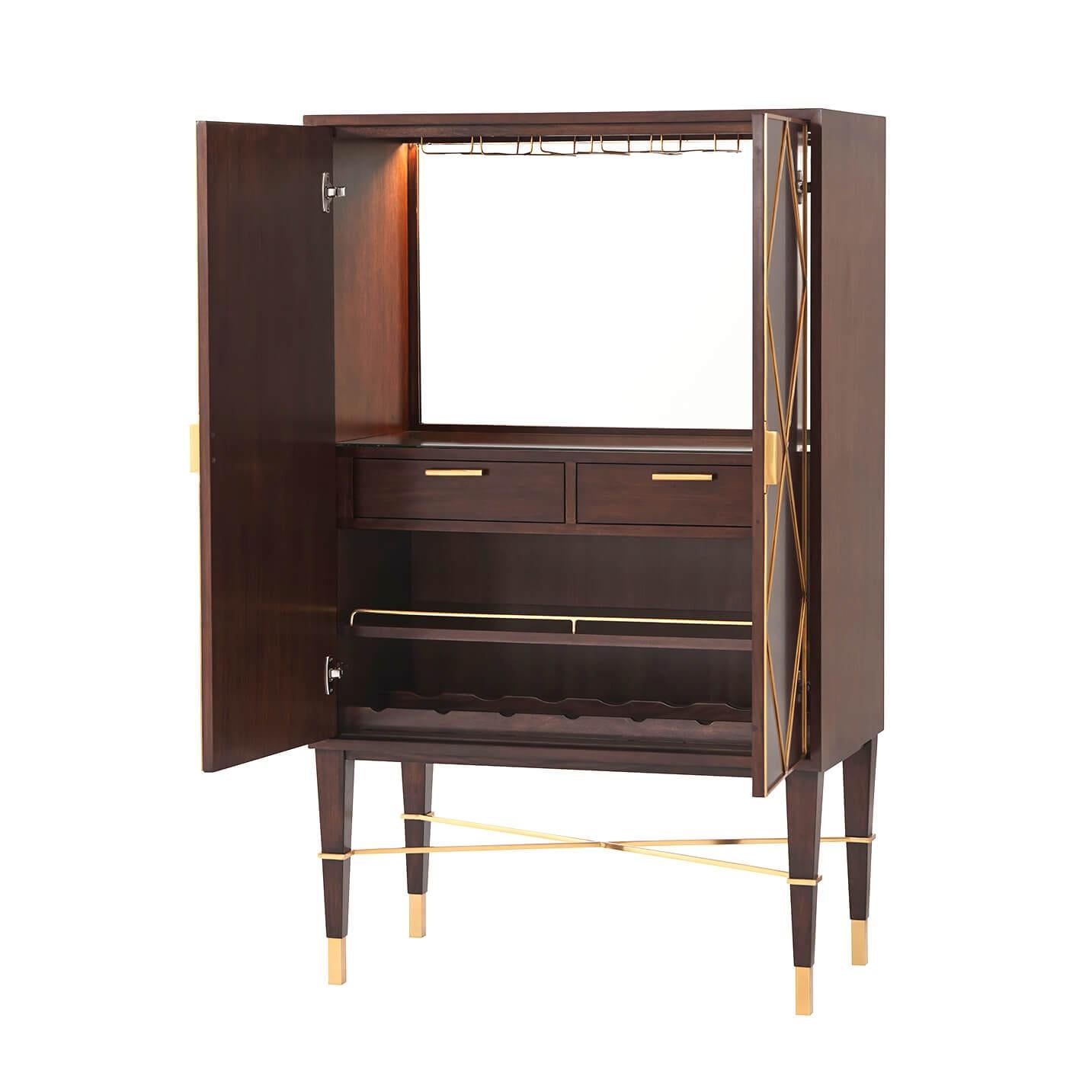 An intoxicating Mid-Century Modern bar cabinet. Mahogany parquet door fronts are overlaid with geometric brass diamond trim and Y handles. Set on square tapered legs with a brass X stretcher. Inside, the liquor cabinet is LED-lit with a mirror back,