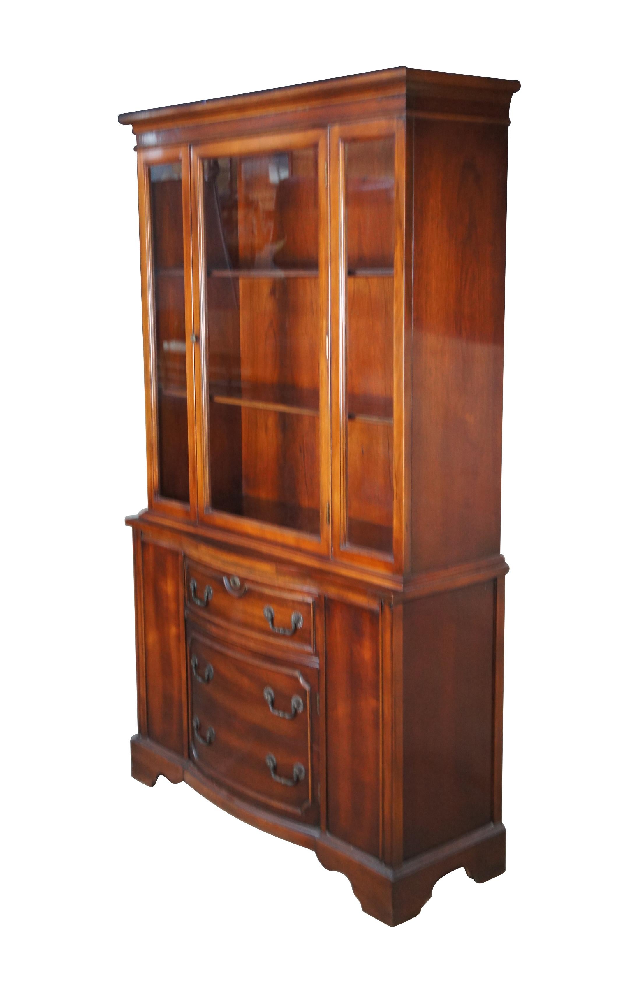 Mid century china cabinet or cupboard.  Made of mahogany featuring upper curio cabinet with three plate groove shelves and lower cabinet and drawer over bracket feet.

Dimensions:
16