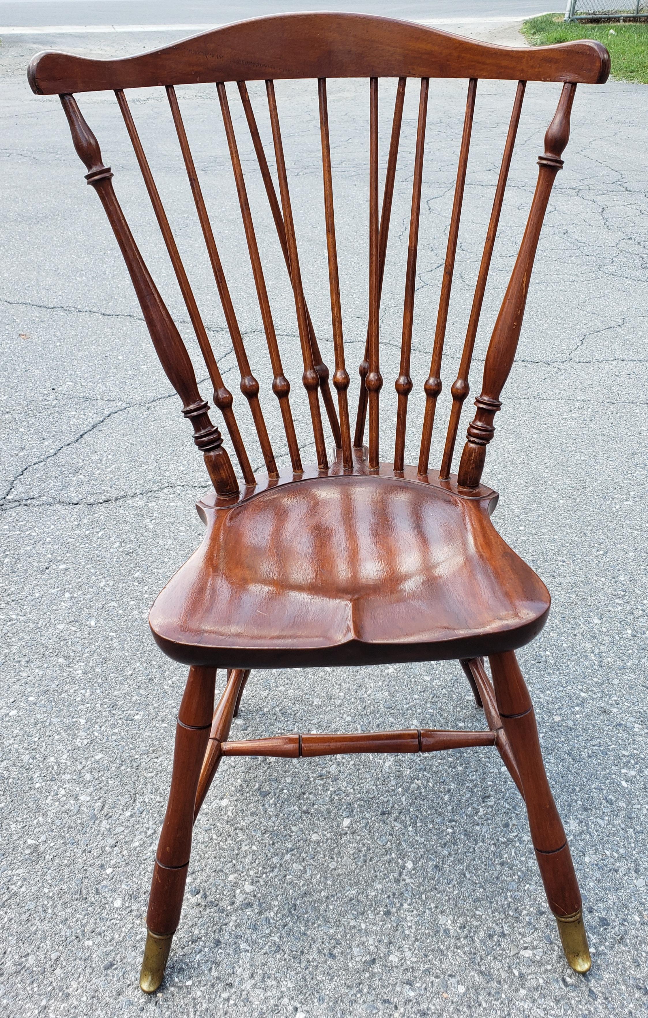 An exceptional hand crafted Mid-Century Mahogany Brace Back Sadle Seat Windsor Chair With high Brass Leg Caps. Recently refinished and in great vintage condition. Measures 23.5
