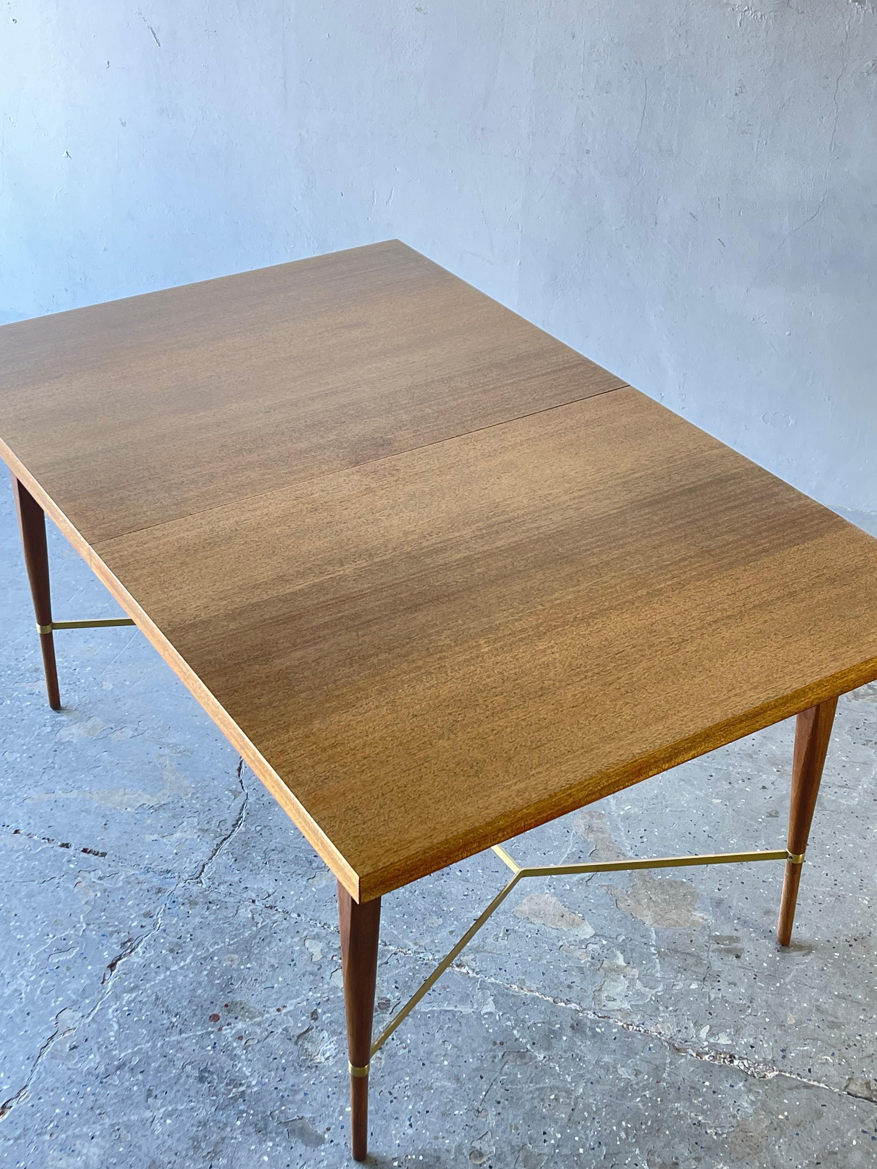 1950s mahogany & brass X cross support extension dining table by Paul McCobb.

A very handsome vintage 1950s extension dining table in mahogany with brass stretcher by Paul McCobb for Calvin. Nice size and details with two extension