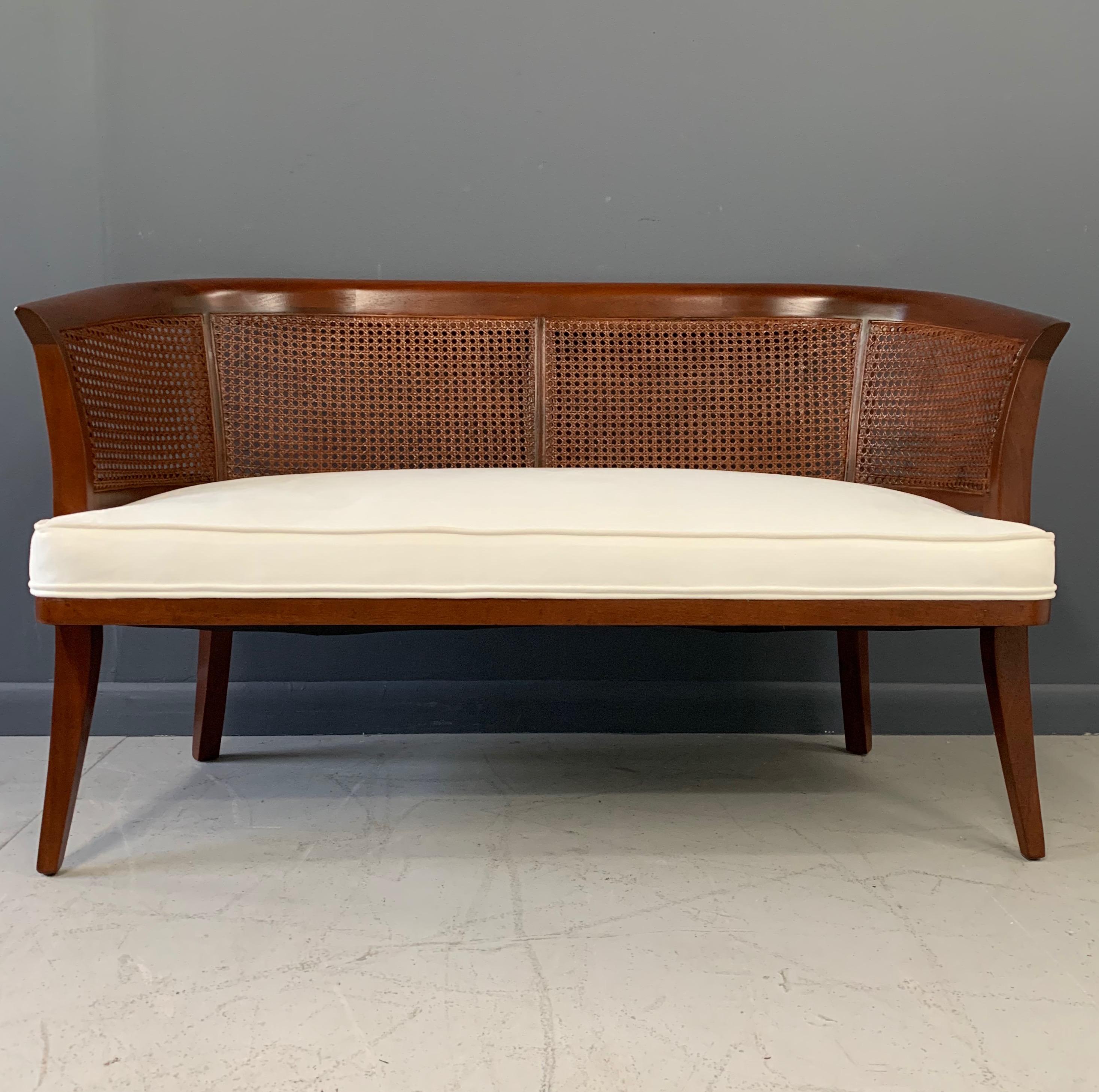 This Classic bench has been newly refinished and reupholstered in a white micro fibre. With its curved back and saber legs, this bench would be a welcome addition to any decor.

The saber leg design is a staple of midcentury designers such as: