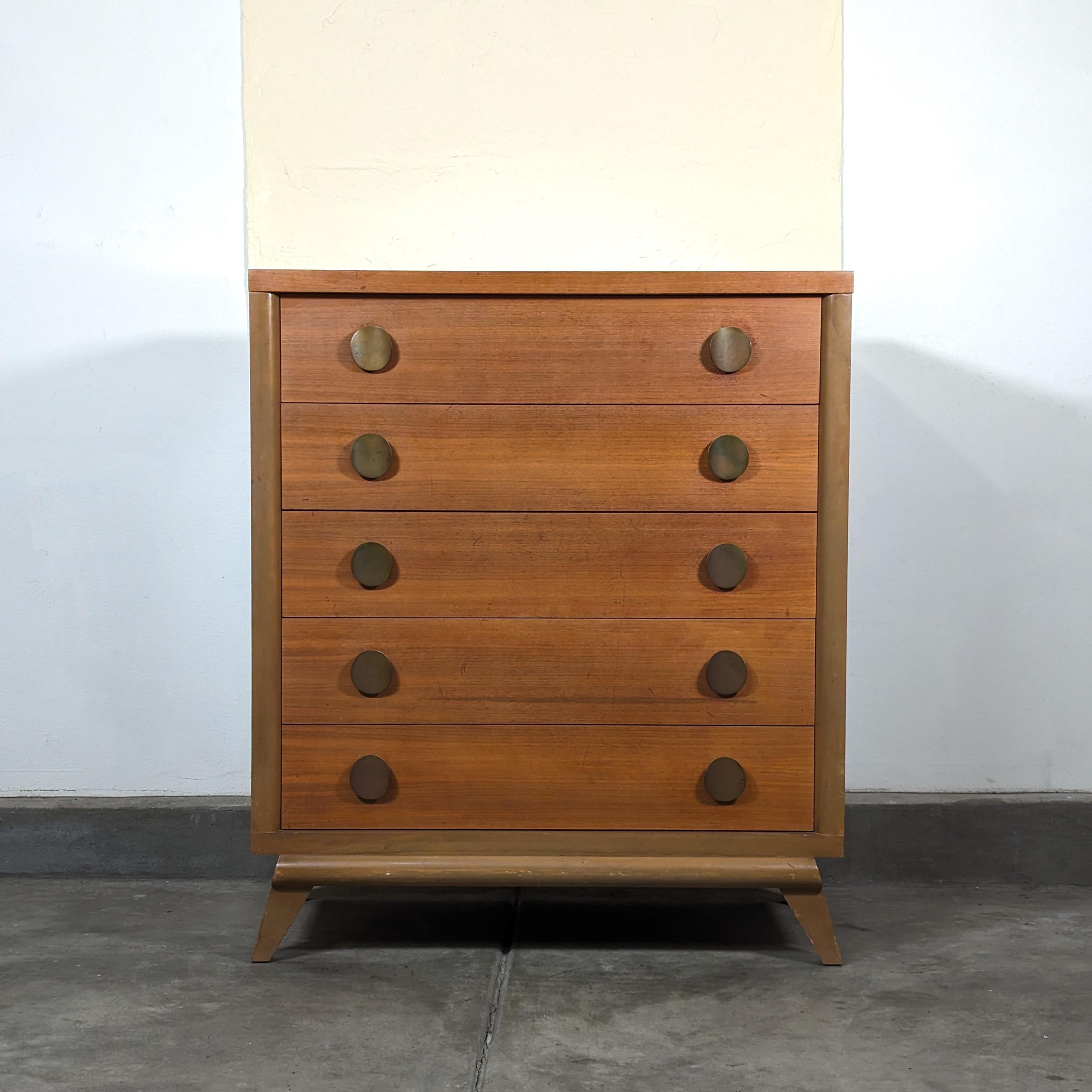 Step back in time and infuse your home with a piece of history through this exquisite vintage mid-century modern tallboy dresser, reminiscent of the iconic Harmony House Furniture of the 1950s. Crafted with an eye for design and functionality, this