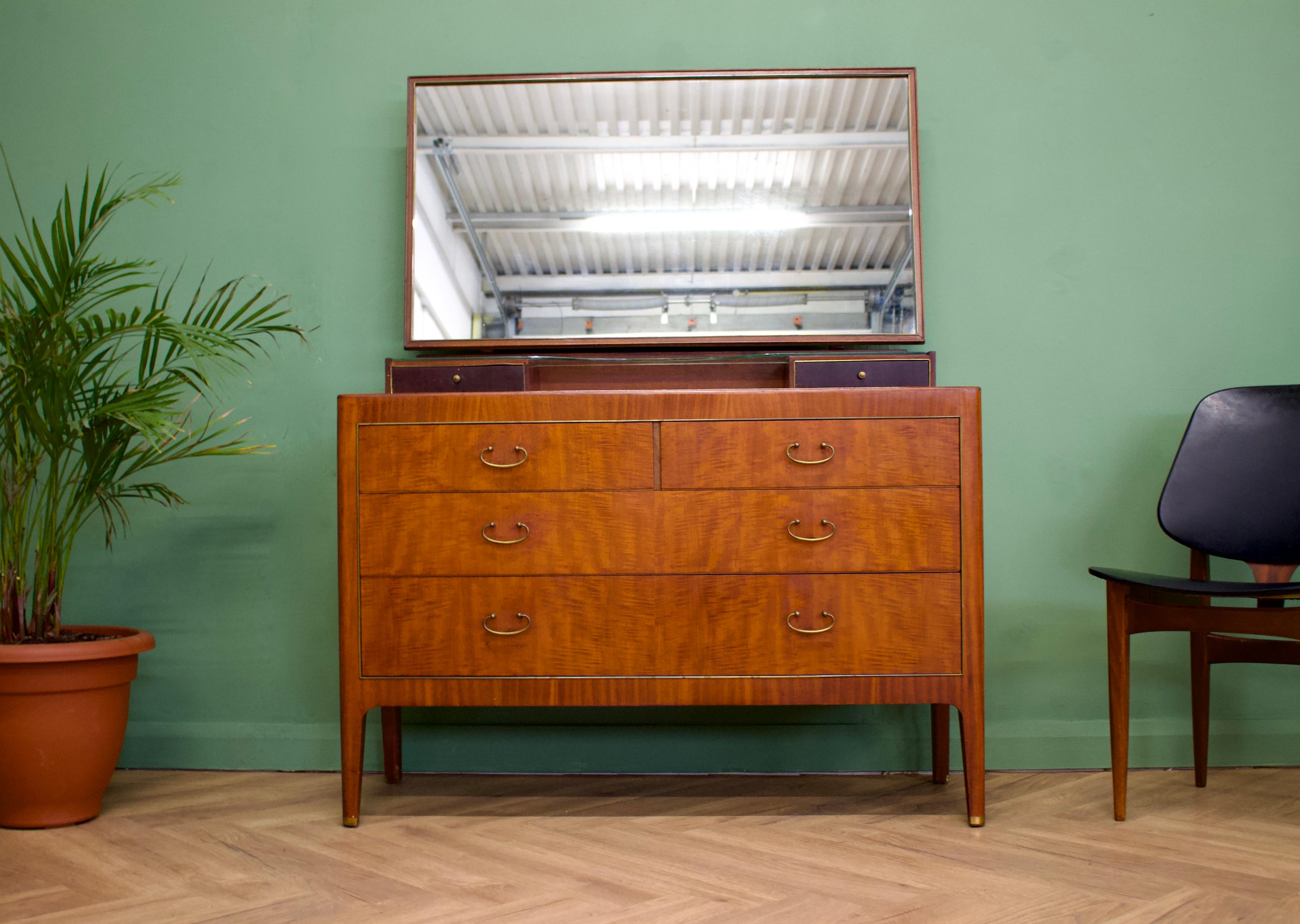 - Mid-Century Modern dressing chest 
- Manufactured by Greaves and Thomas in the UK .

- Made from mahogany and mahogany veneers.
- Featuring two small drawers to the top - and four drawers to the chest
- The glass shelf is removable