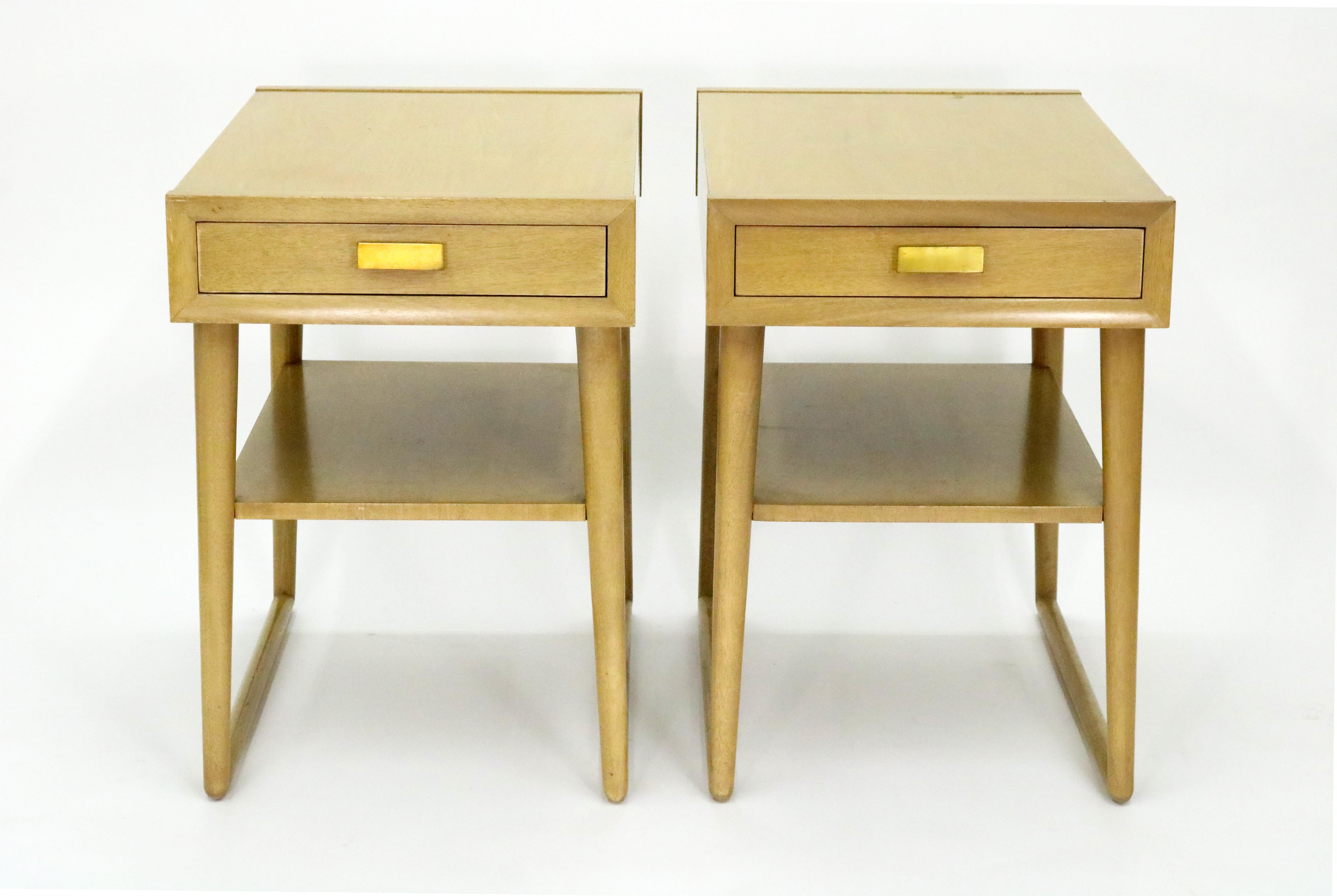 An architectural pair of early 1950s mahogany end tables or night stands by Imperial Furniture of Grand Rapids. Single drawer and magazine shelf in each table. Gilded metal pulls.

These handsome tables strike a visually captivating profile from