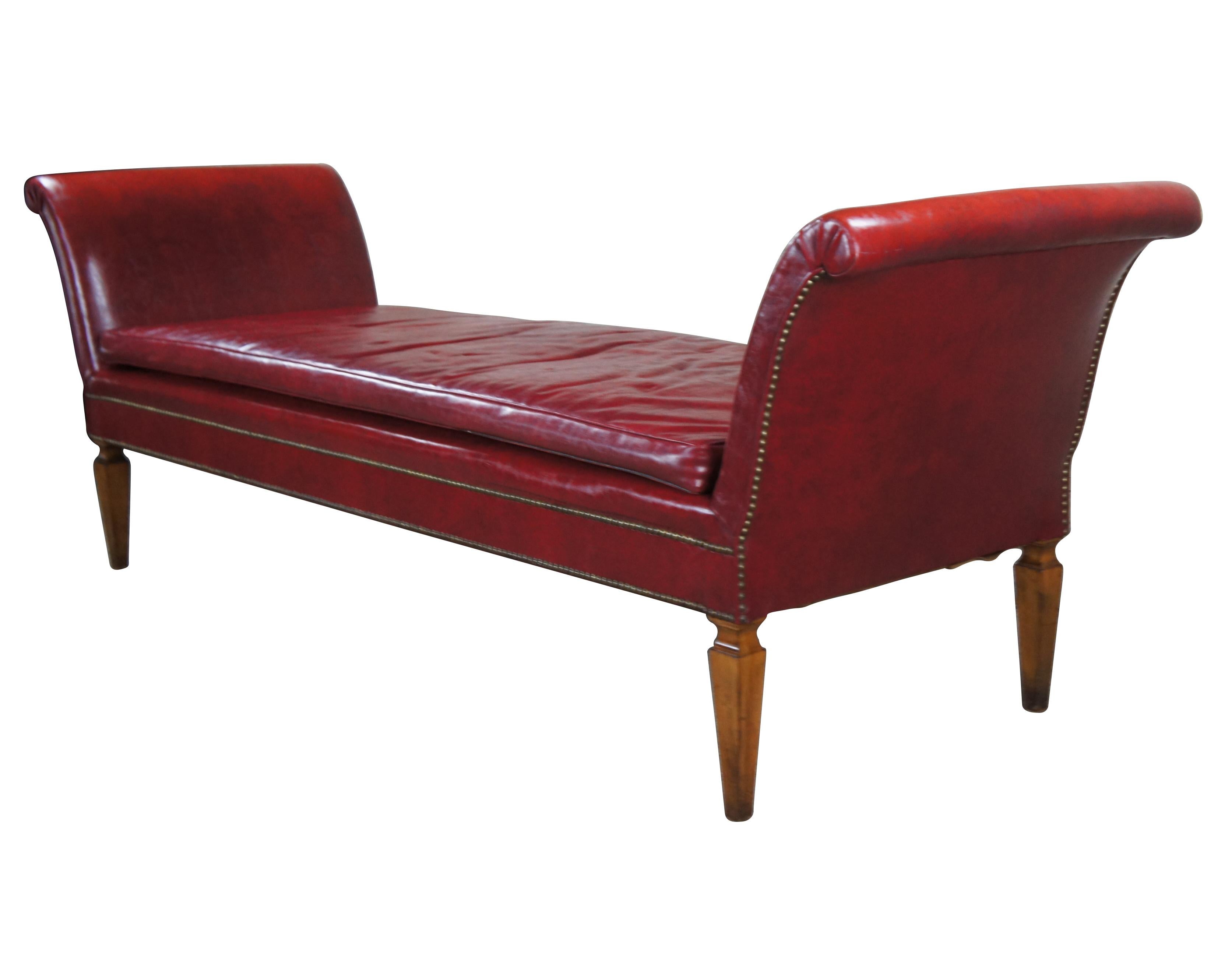 Large Mid-20th Century Chaise Lounge, bench or daybed. Features a long red leather upholstered frame with flared and scrolled arms over square tapered mahogany feet. Includes nailhead trim.
