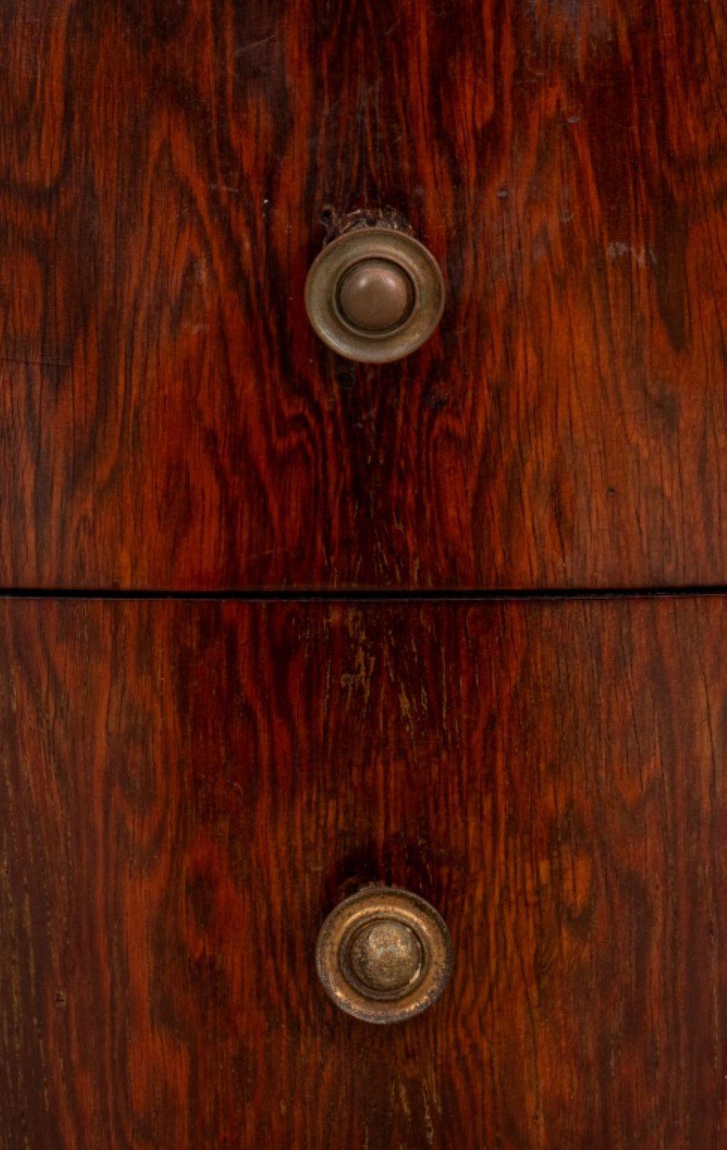 Pair of Mid-Century Mahogany Side Cabinets, in the late Art Deco taste with bookmatched tops above a bow fronted short drawer and conforming cabinet door.
