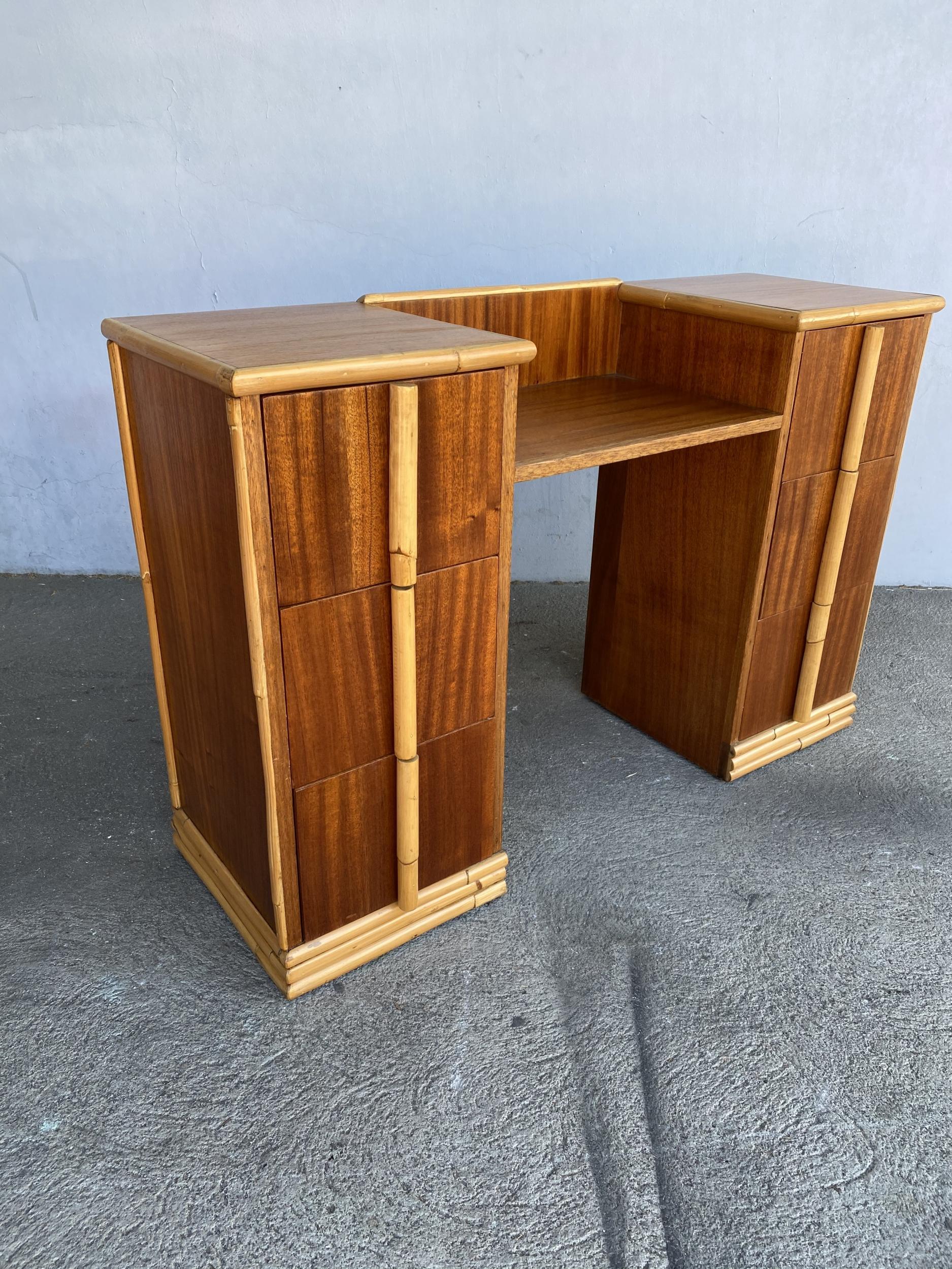 Original 1940s midcentury mahogany vanity with rattan accents. The vanity features an extensive rattan trim along the mahogany surface and custom made rattan pulls.

Restored to new for you.

All rattan, bamboo, and wicker furniture has been