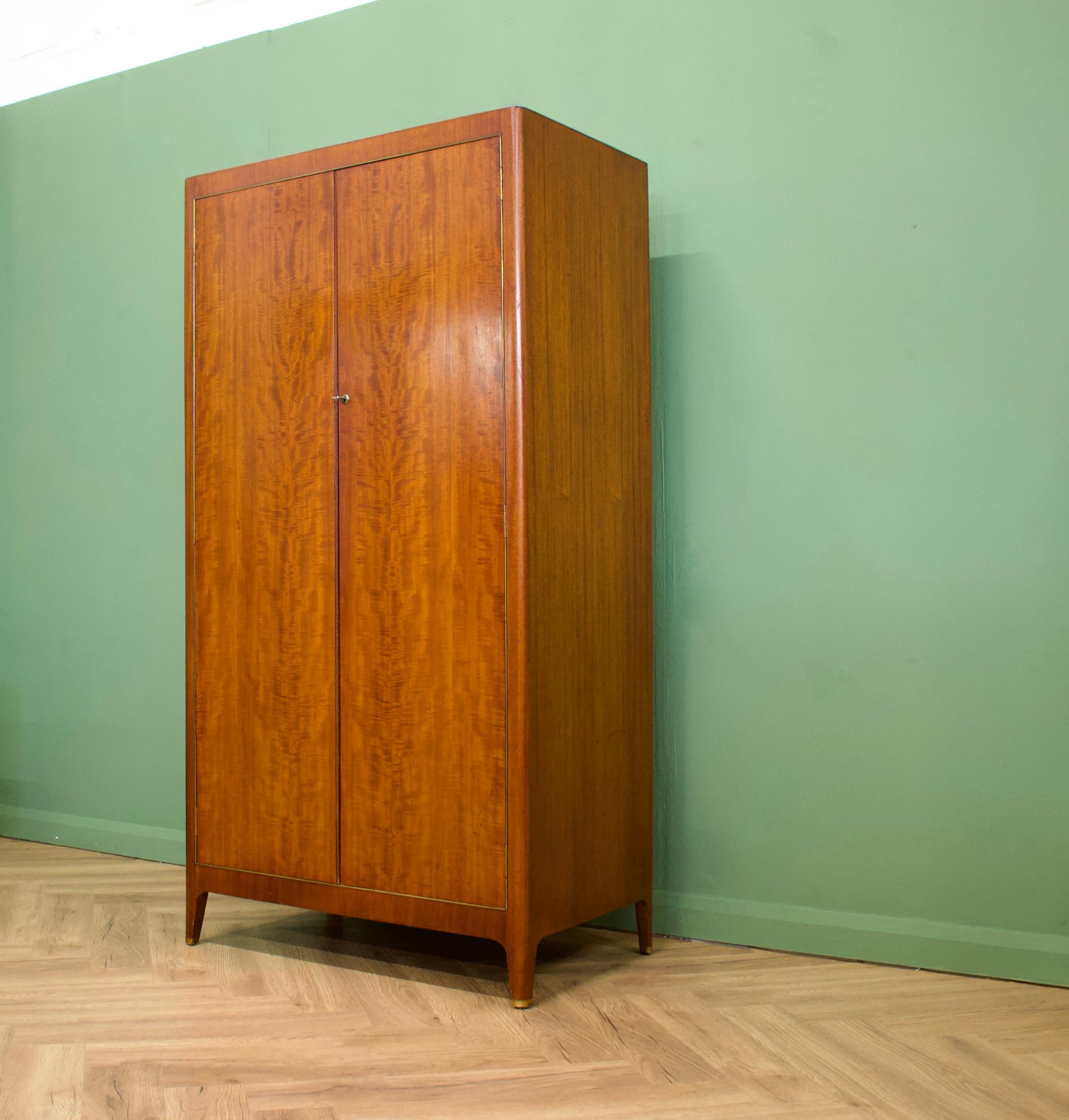 - Mid-Century Modern wardrobe.
- Manufactured by Greaves and Thomas in the UK .

- Made from mahogany and mahogany veneers.
- Featuring a hanging rail and shoe rail
