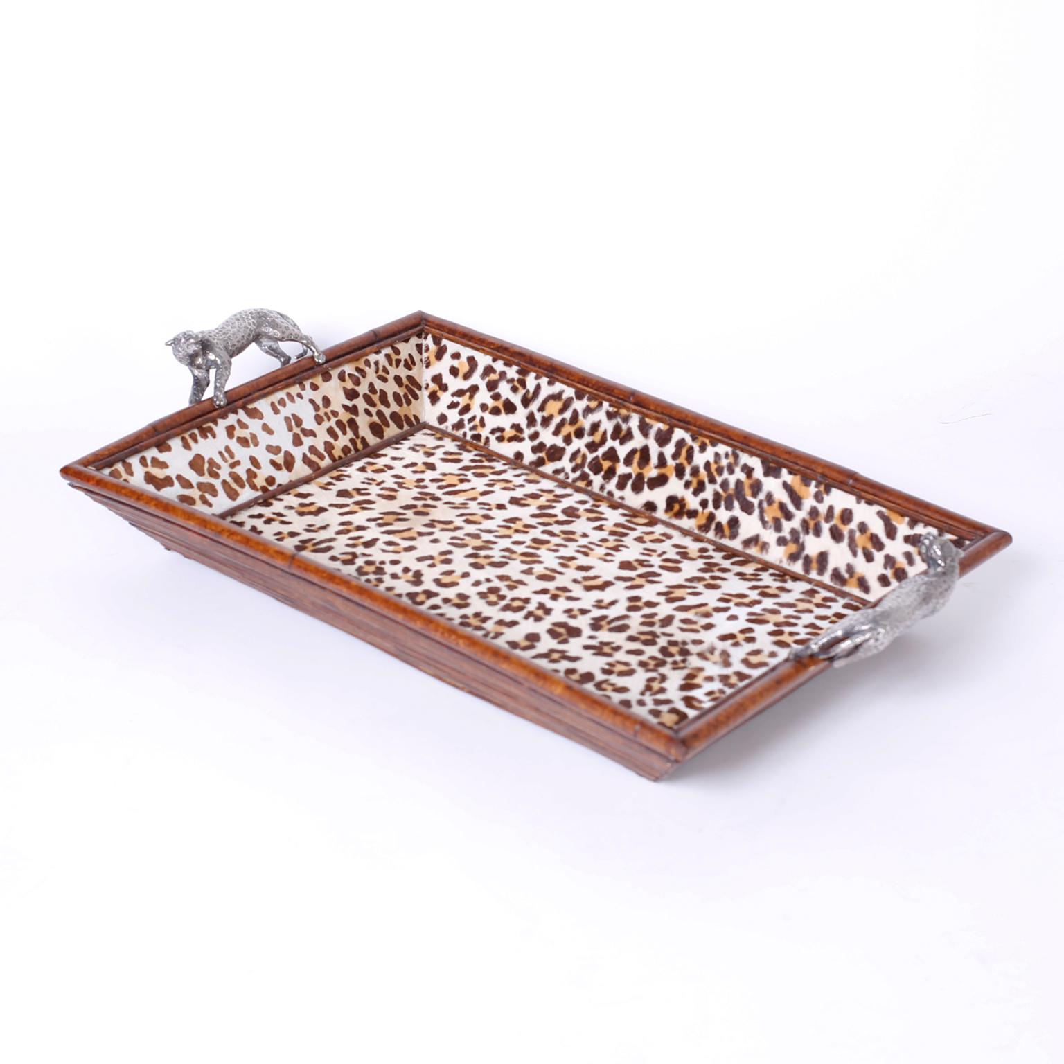 Midcentury rattan tray with silvered metal leopard handles and an interior lined with leopard printed cowhide. Signed Maitland -Smith on the bottom.