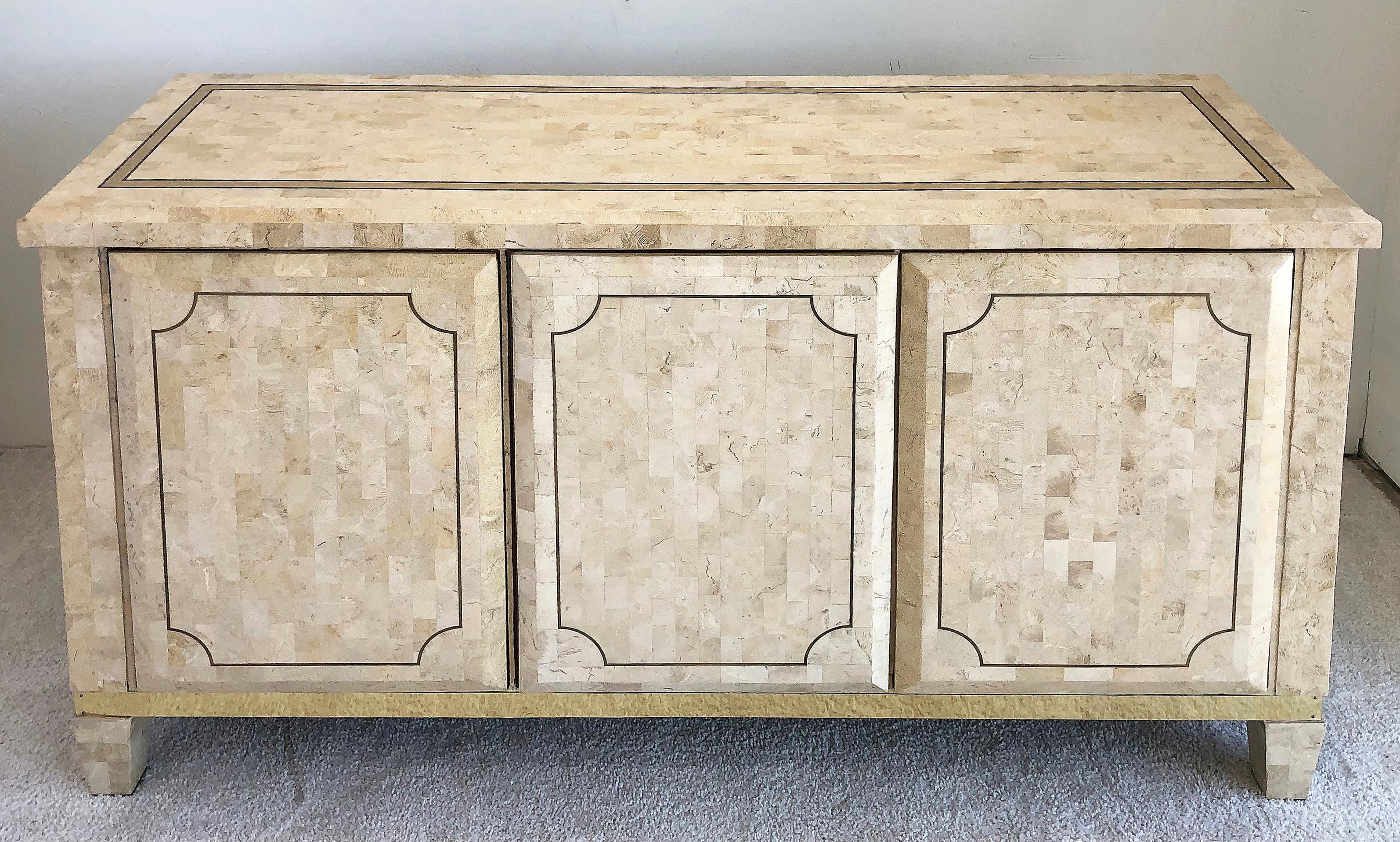 Midcentury Maitland-Smith tessellated stone credenza with brass

Offered for sale is a stunning Mid-Century Modern tessellated stone Maitland Smith credenza. The cabinet has brass inlay and brass details near the base.
The interior of the cabinet